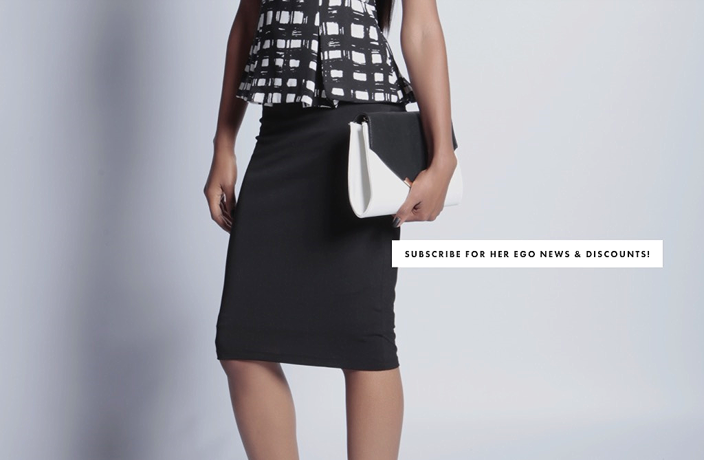 Detailed close up of a woman wearing a black pencil skirt and her black and white monochrome clutch bag. There is also small text on the image that reads "subscribe for Her Ego news and discounts!" 