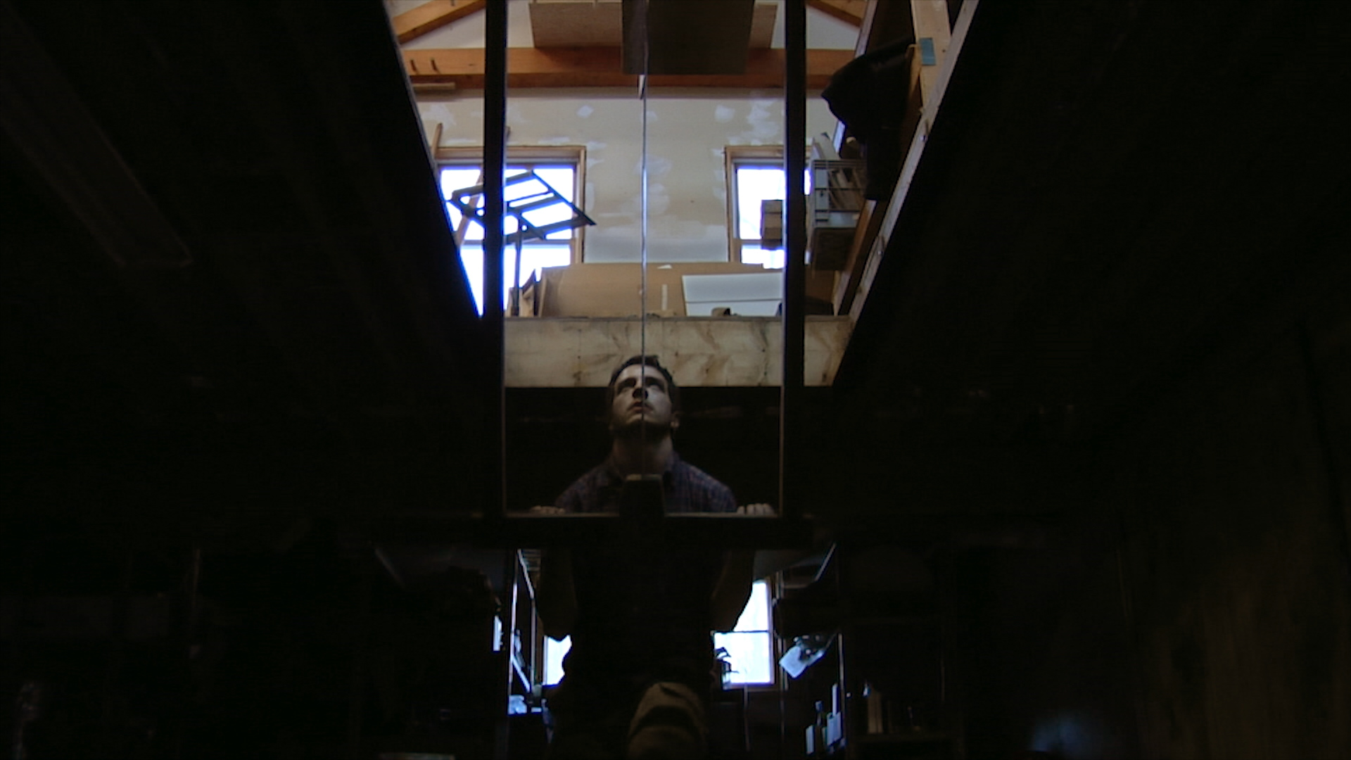 Still 6: Nick Farnham using a pit saw to cut beams for the bimah in the studio at Handshouse.