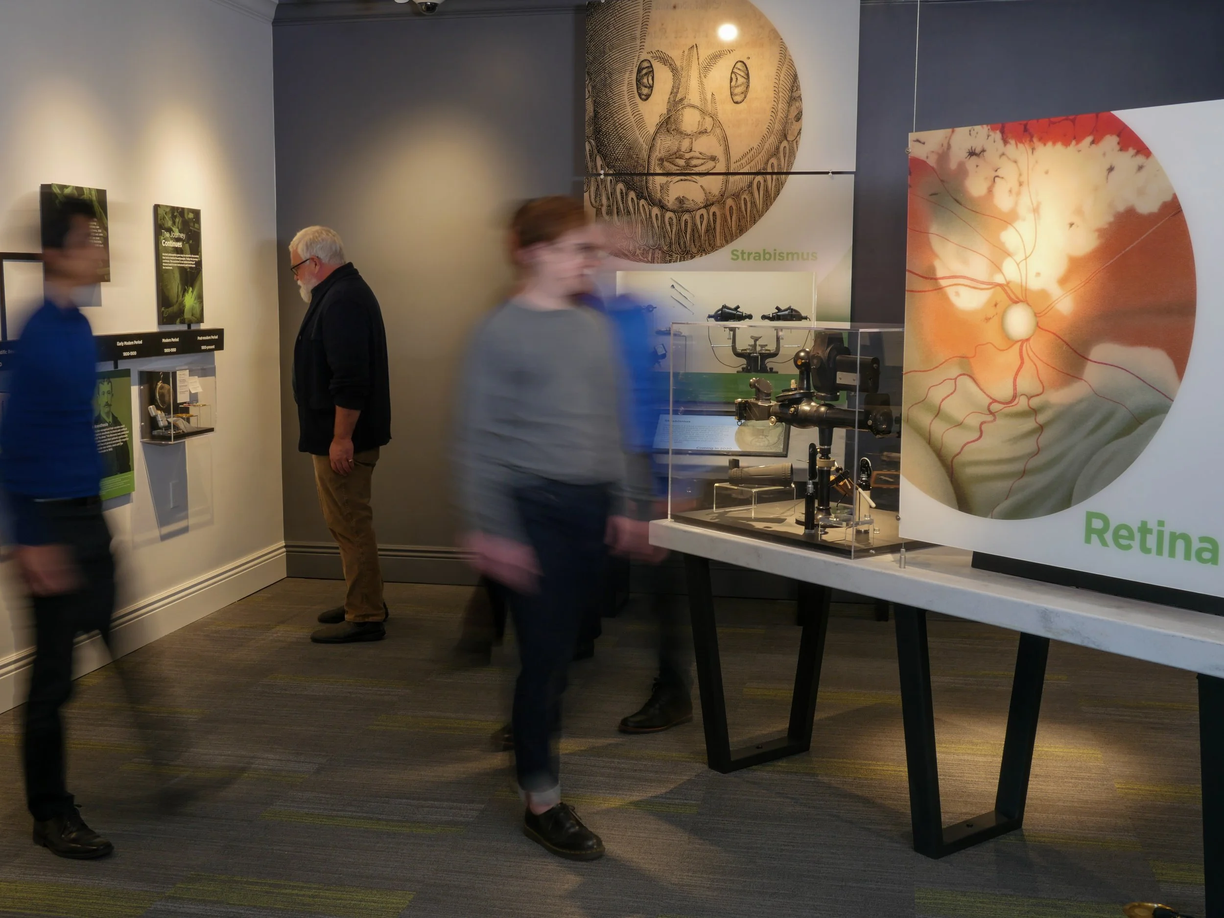Visitors explore historical eye examination instruments and exhibits about the retina and strabismus at the Museum of the Eye.