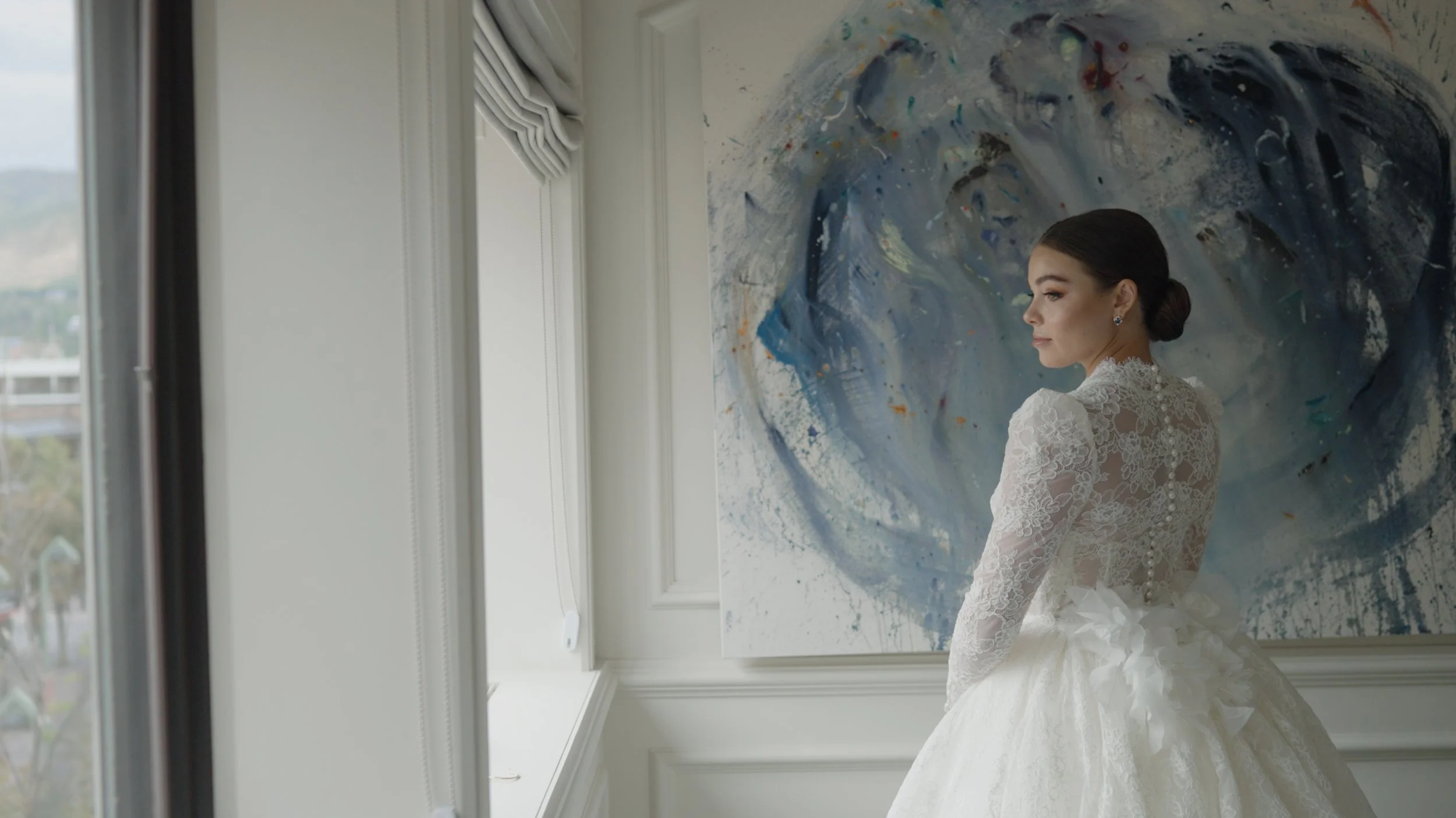 bride in dress in front of painting.jpg