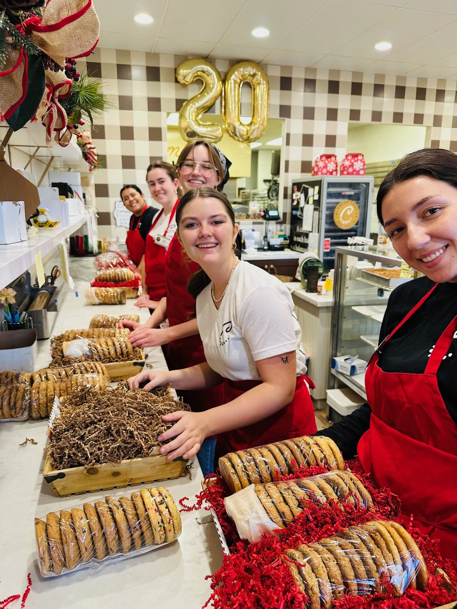 Preparing fresh baked cookies for wine crates.