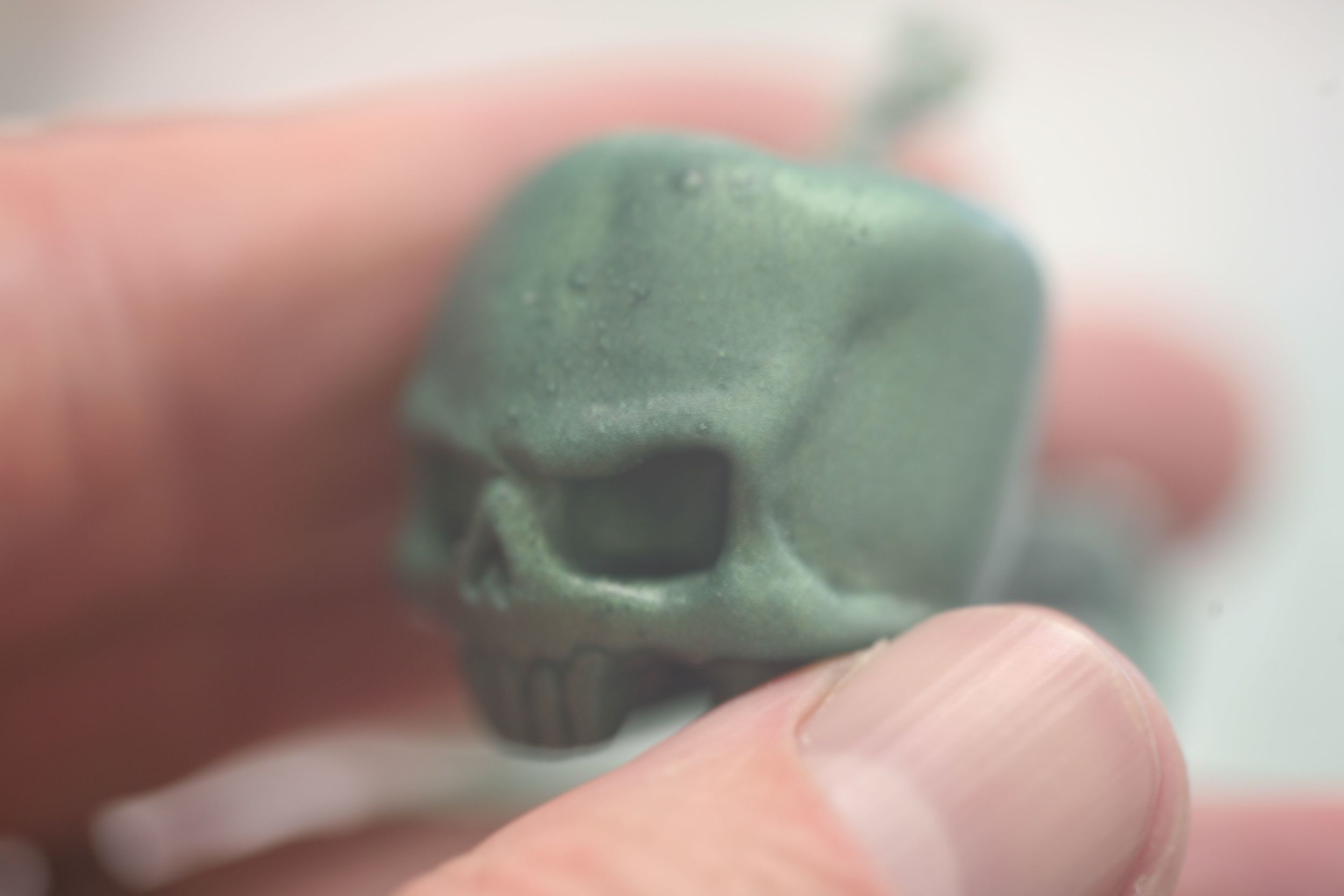 green skull in hand horiz-1.jpg