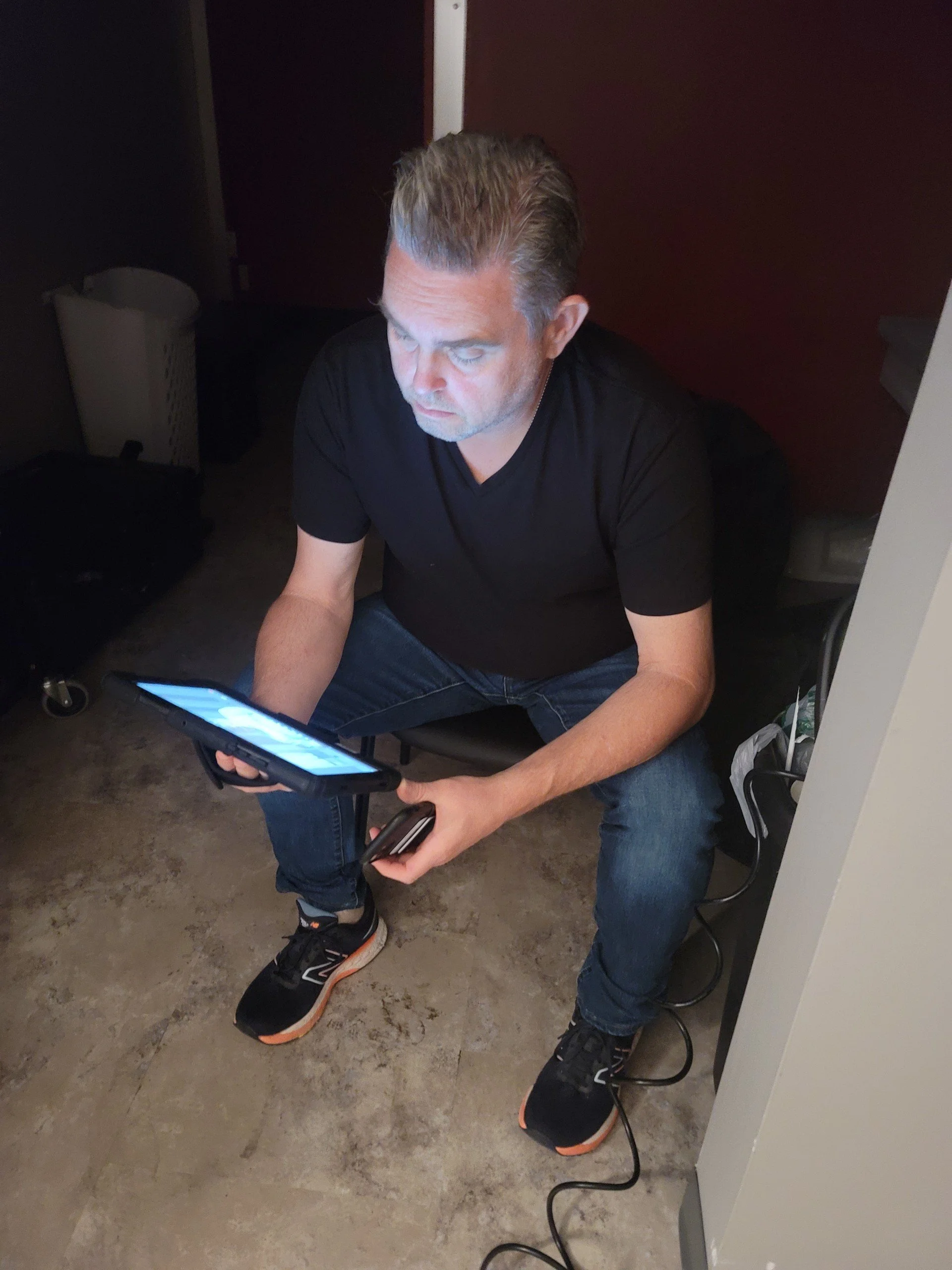 Jason Hensley on set, reviewing footage on a tablet