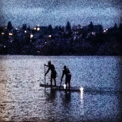Paddle boarders, with what looked like candles on the back of their boards.