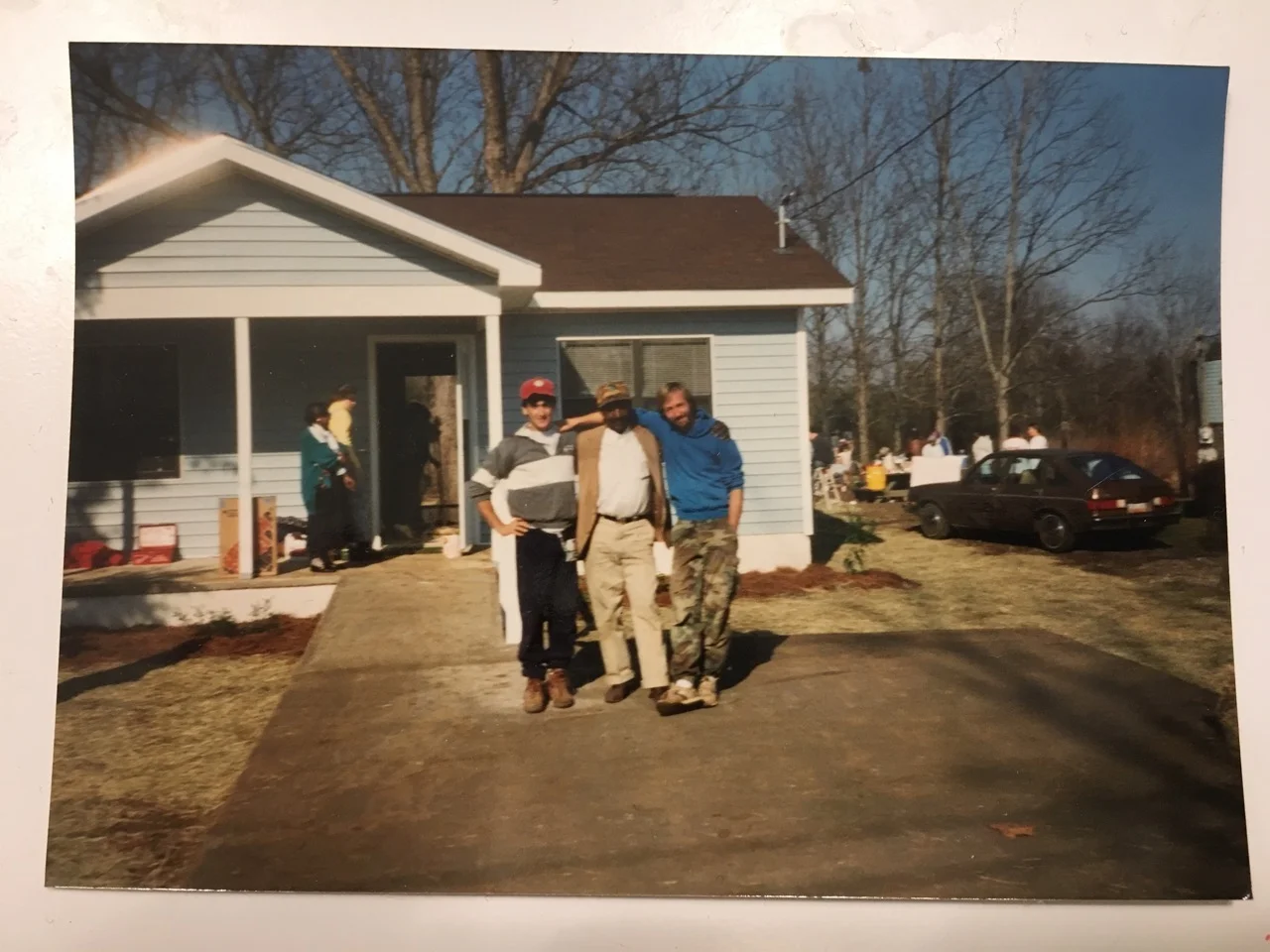 23-year-old Miro in DeSoto, Georgia with another full-time volunteer and new homeowner Anderson Ross (center) on the day the Habitat for Humanity house they built with the community was dedicated. “I am overjoyed,” Mr. Ross told Miro, helping to spark Miro's 15-year career in low-income affordable housing development.