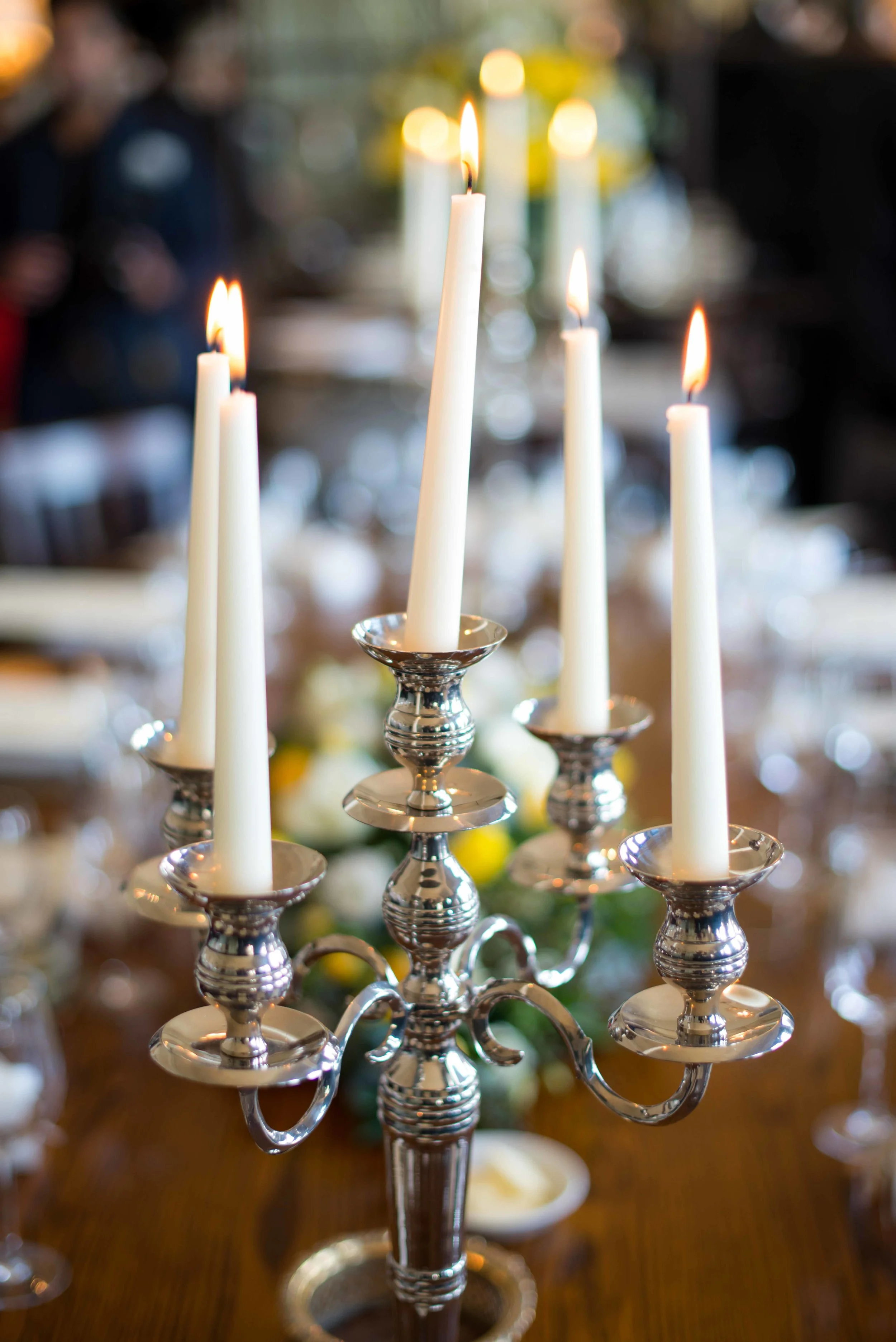 beautiful candles on wedding table with framed fantasies photography