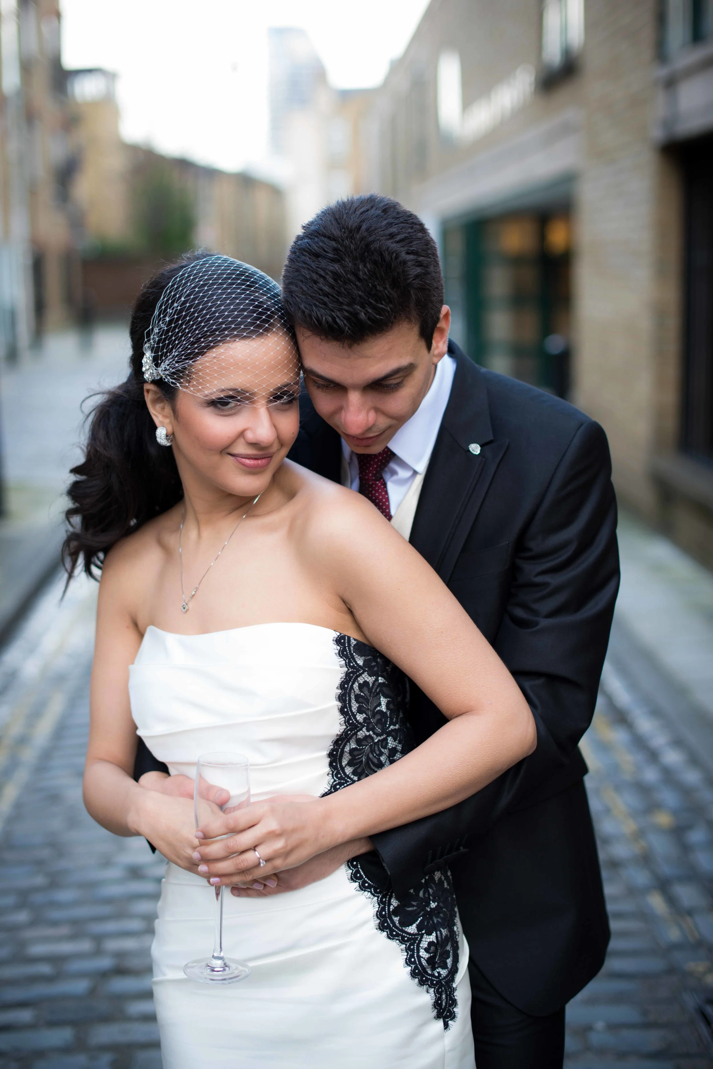 bride and groom embrace on their wedding day with framed fantasies photography