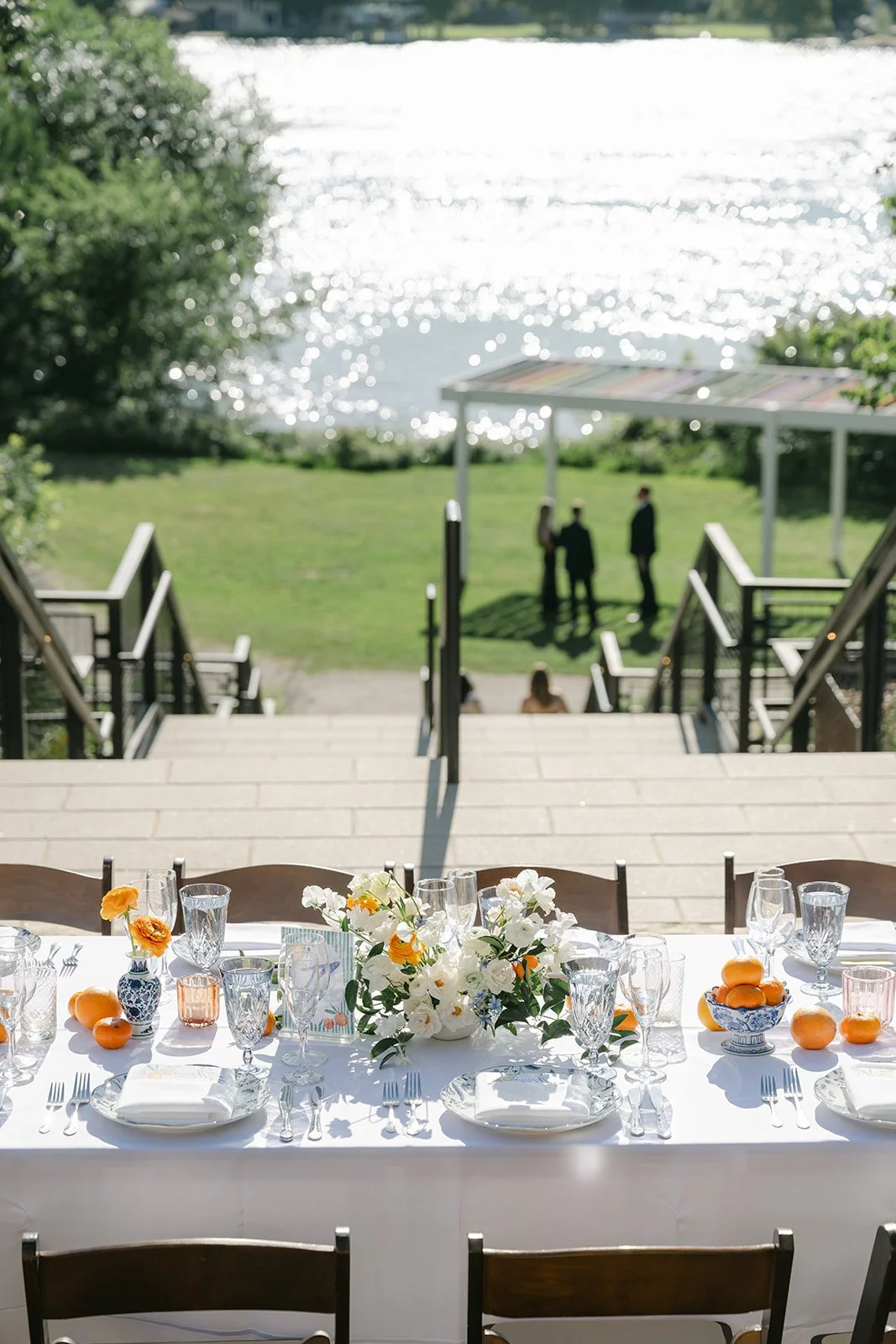 Timeless tablescape with neutral blooms and pops of oranges.jpeg