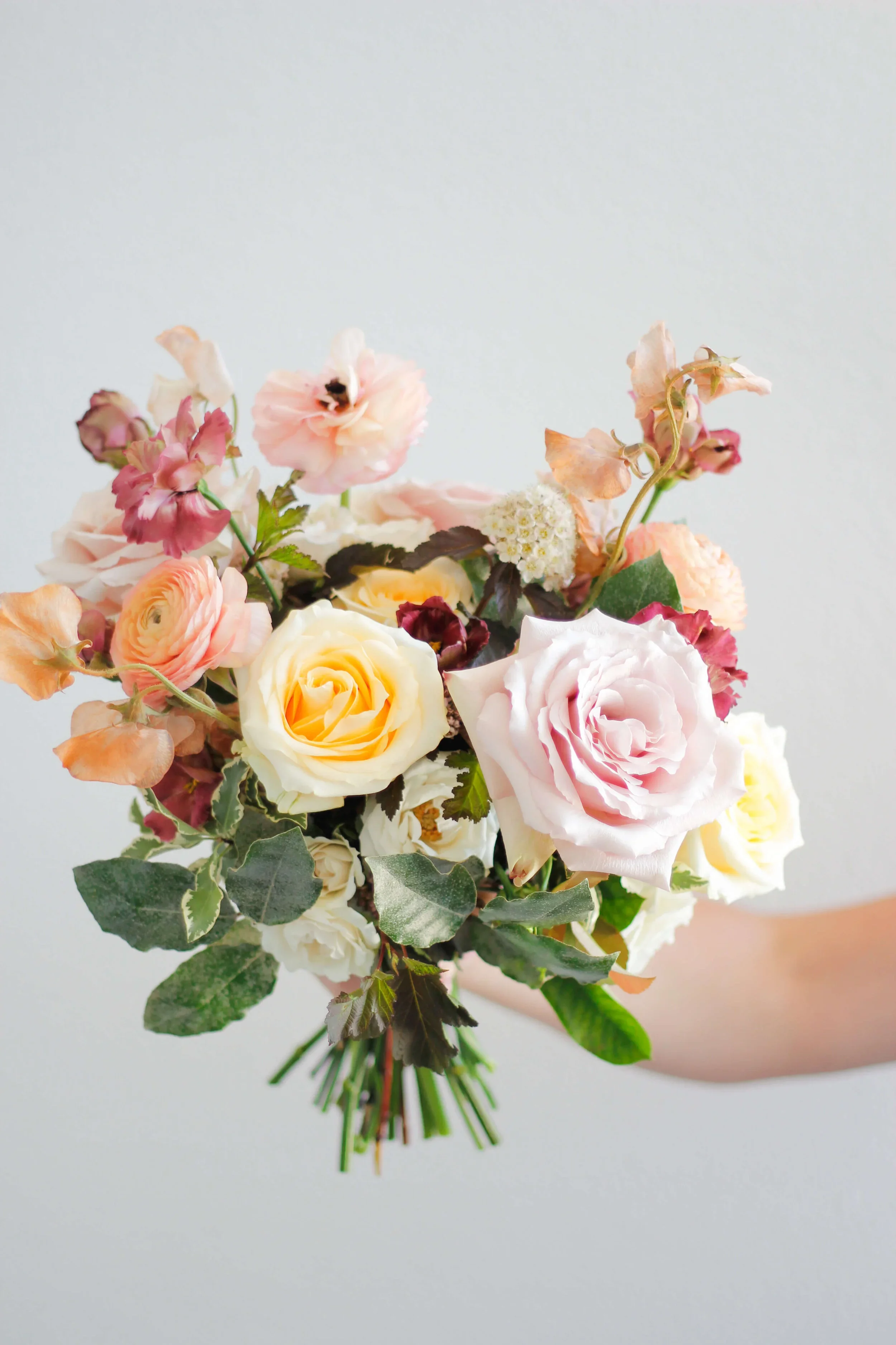 Soft romantic bouquet featuring layered blooms and greenery.jpg.webp