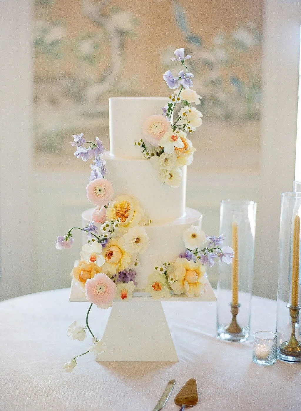 Romantic wedding flowers whimsically layered on wedding cake.jpg.webp