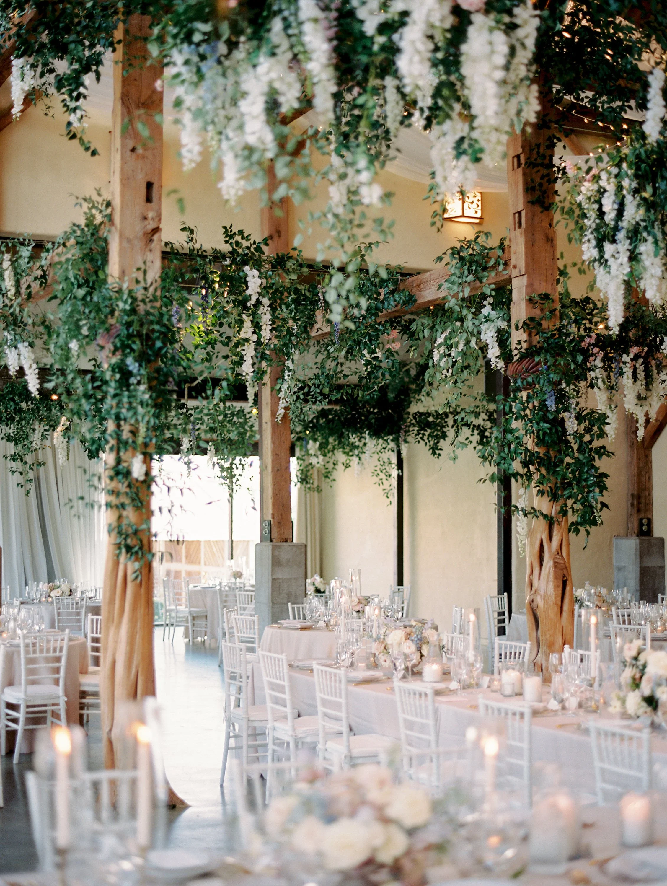Elegant reception florals with dripping ceiling greenery.jpg.webp