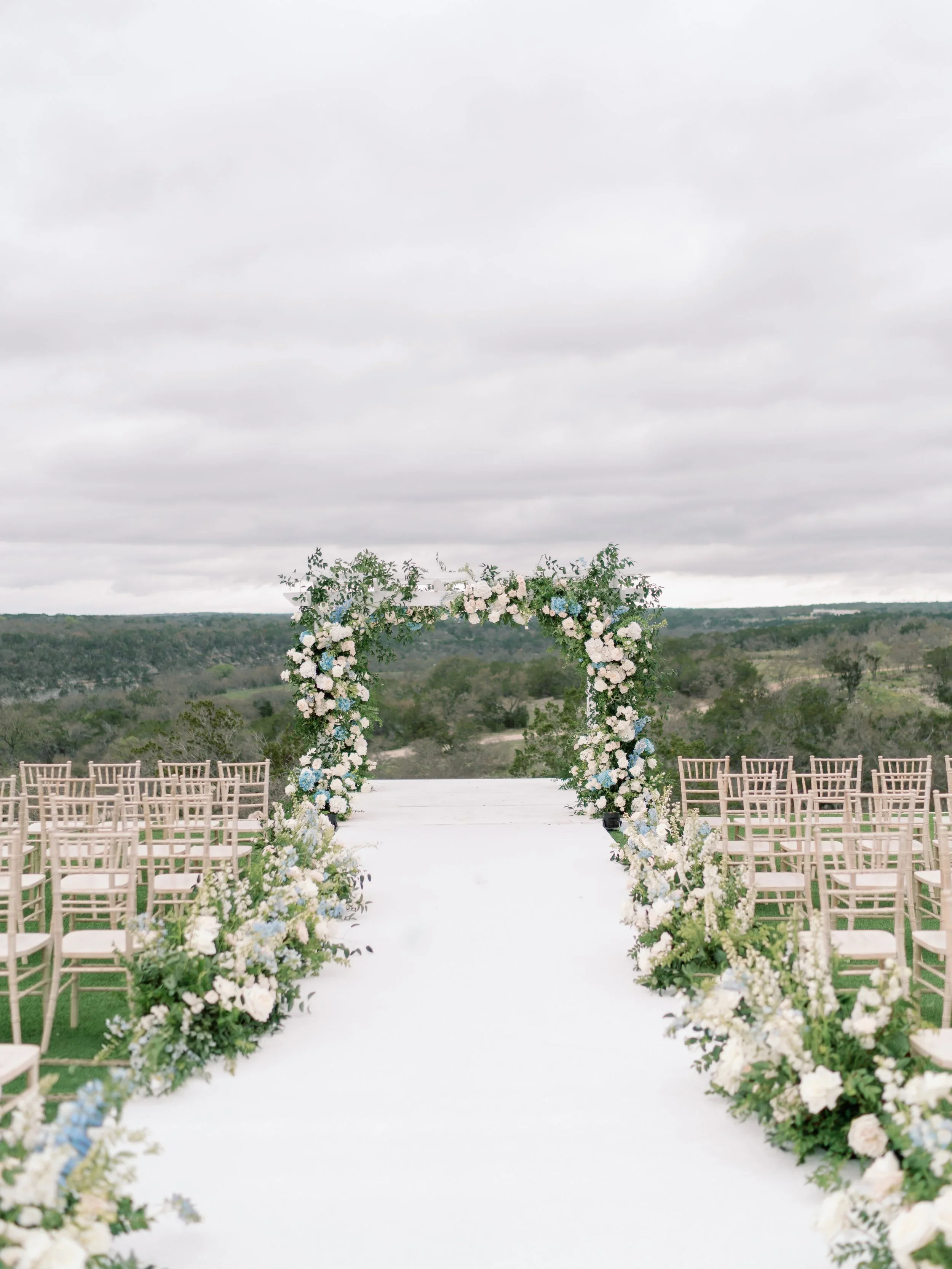 Refined classic ceremony arch florals by an Austin floral designer.jpeg.webp