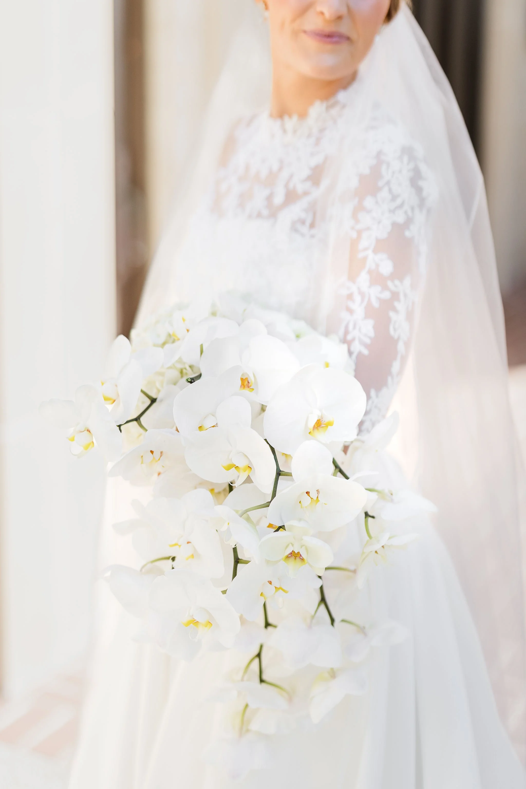 Refined wedding bouquet with traditional orchids and cascading styling.jpeg