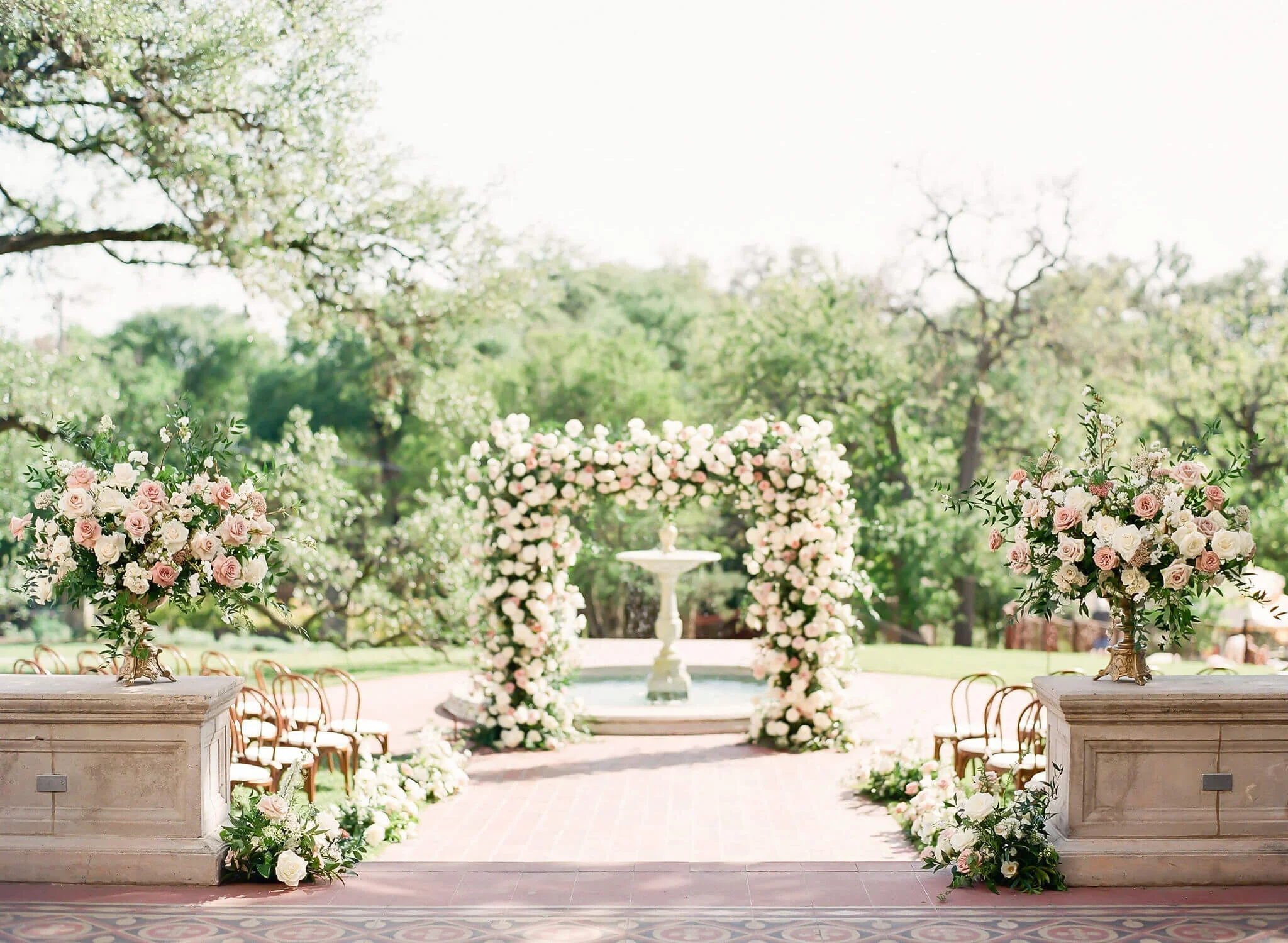 Traditional wedding ceremony florals with lush roses.jpg.webp
