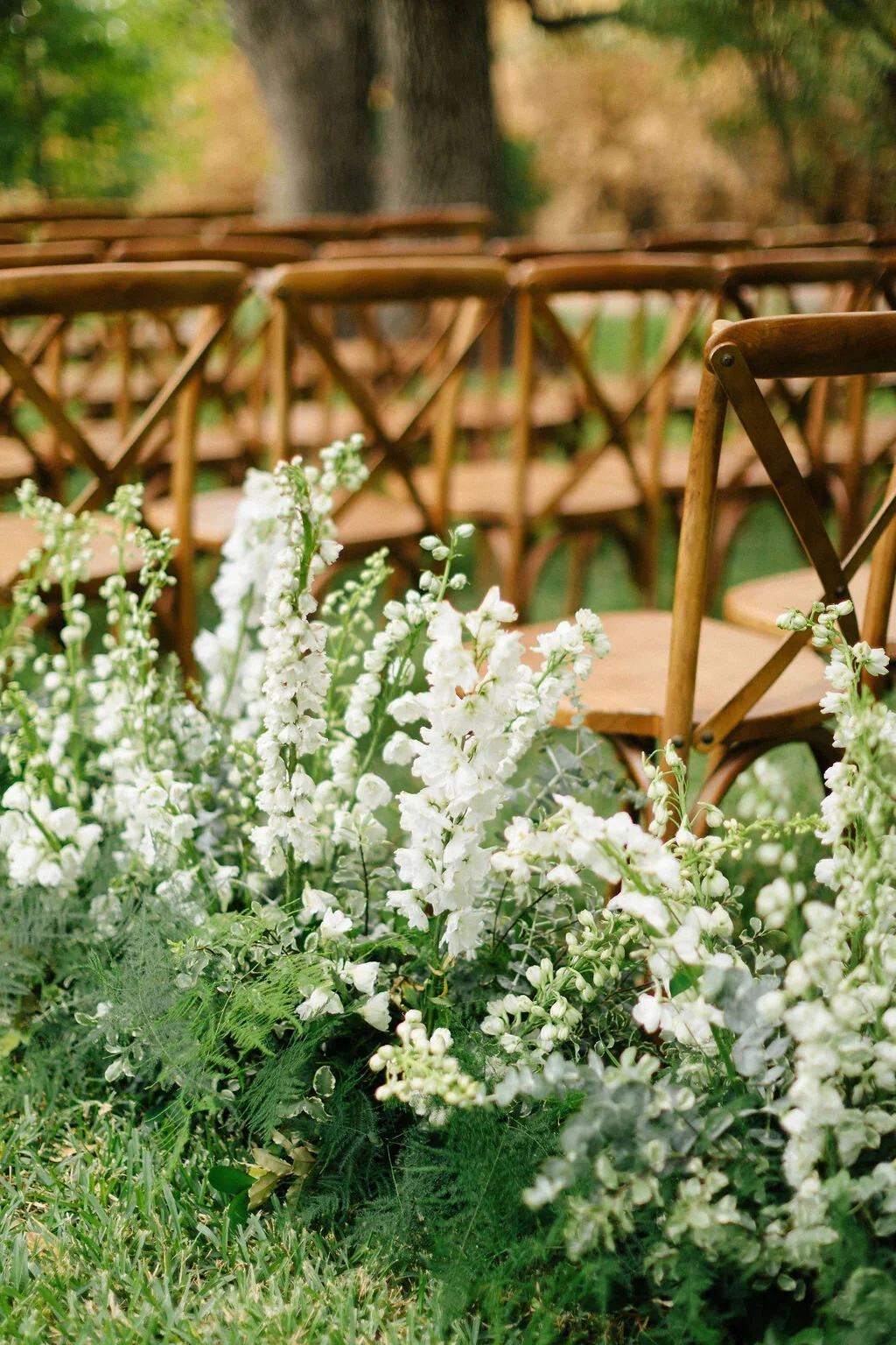White and green wedding aisle by an Austin florist.jpg.webp