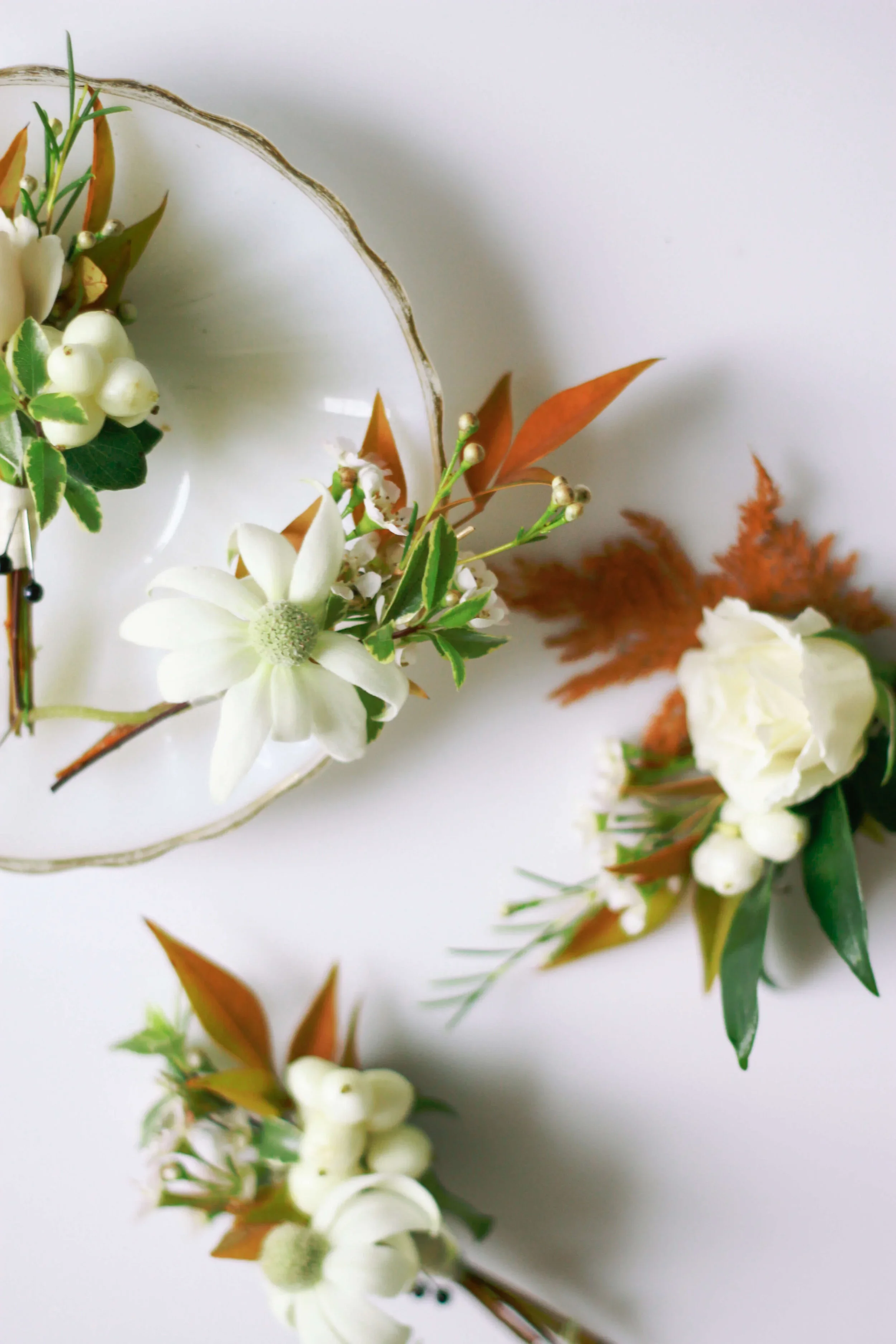 Dainty romantic boutonnieres with natural foliage.jpg.webp