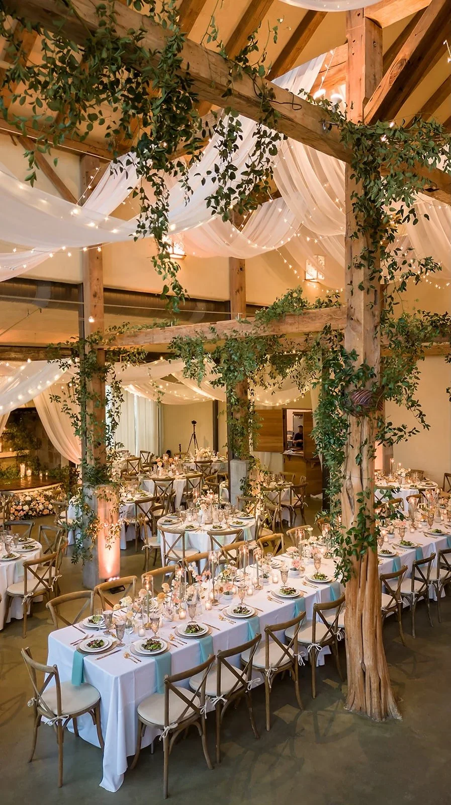 Greenery on beams at Barr Mansion wedding venue austin texas.webp