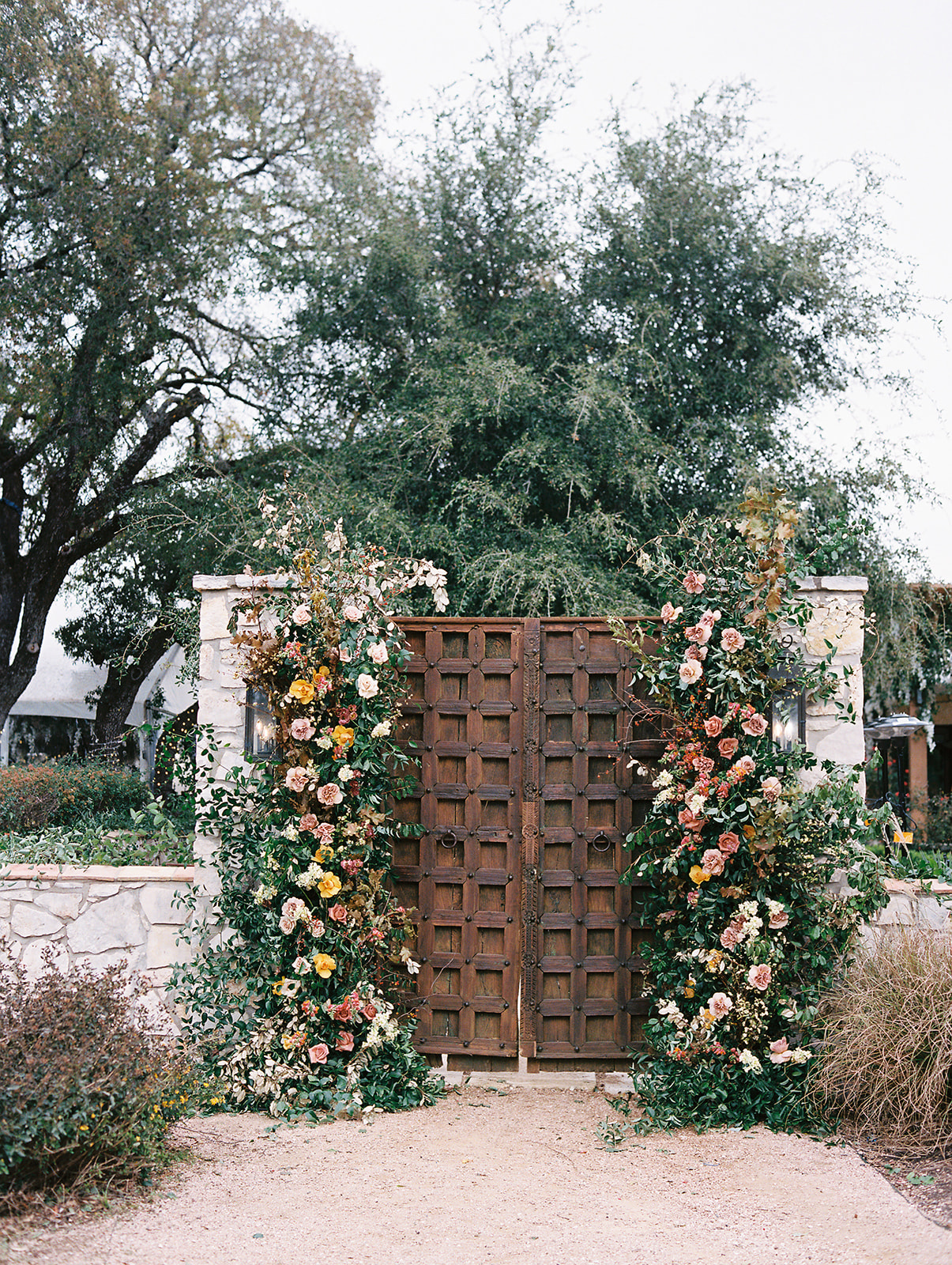 Statement floral installation designed to frame a wedding space.webp