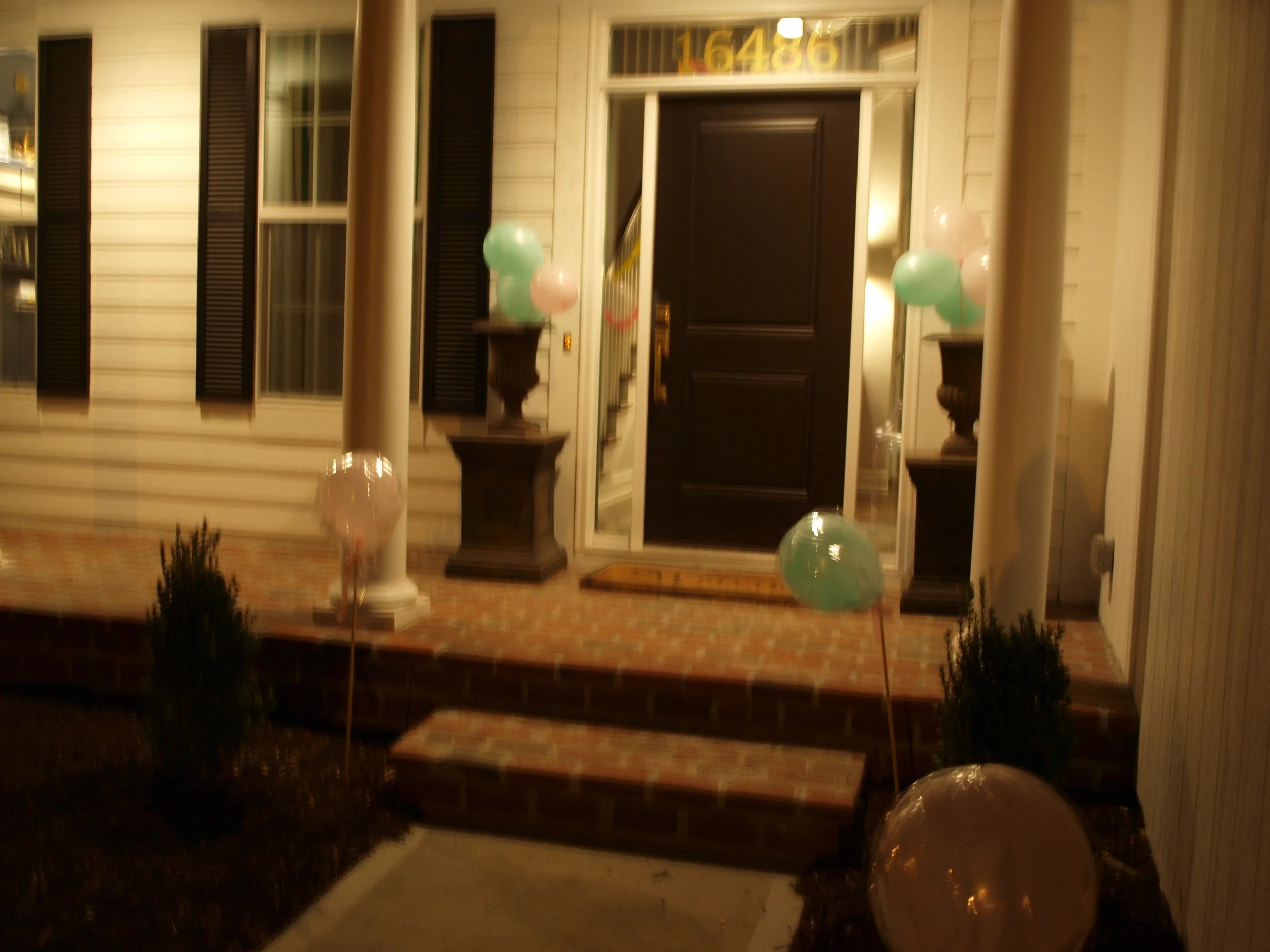 Balloons were wrapped in cellophane wrapping paper and put on a stick to create large lollipops.
