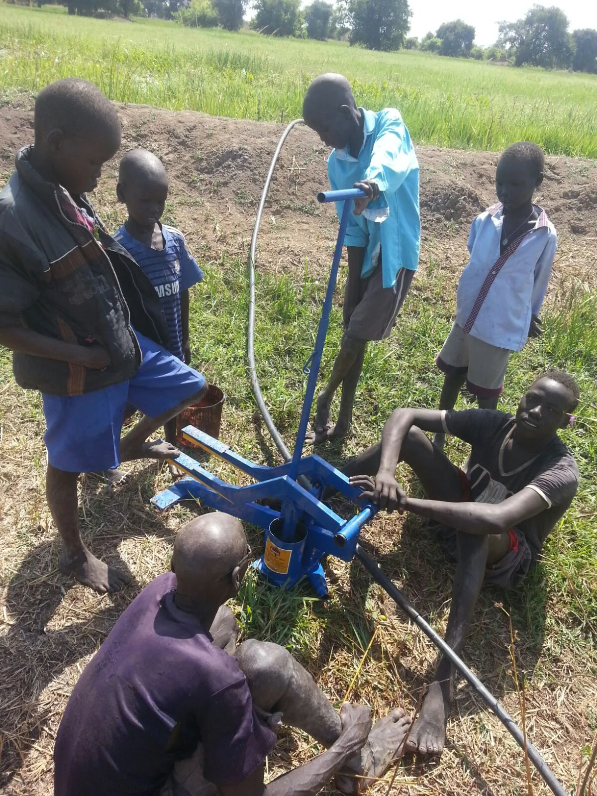  Children from NCC pumping water out of ground 