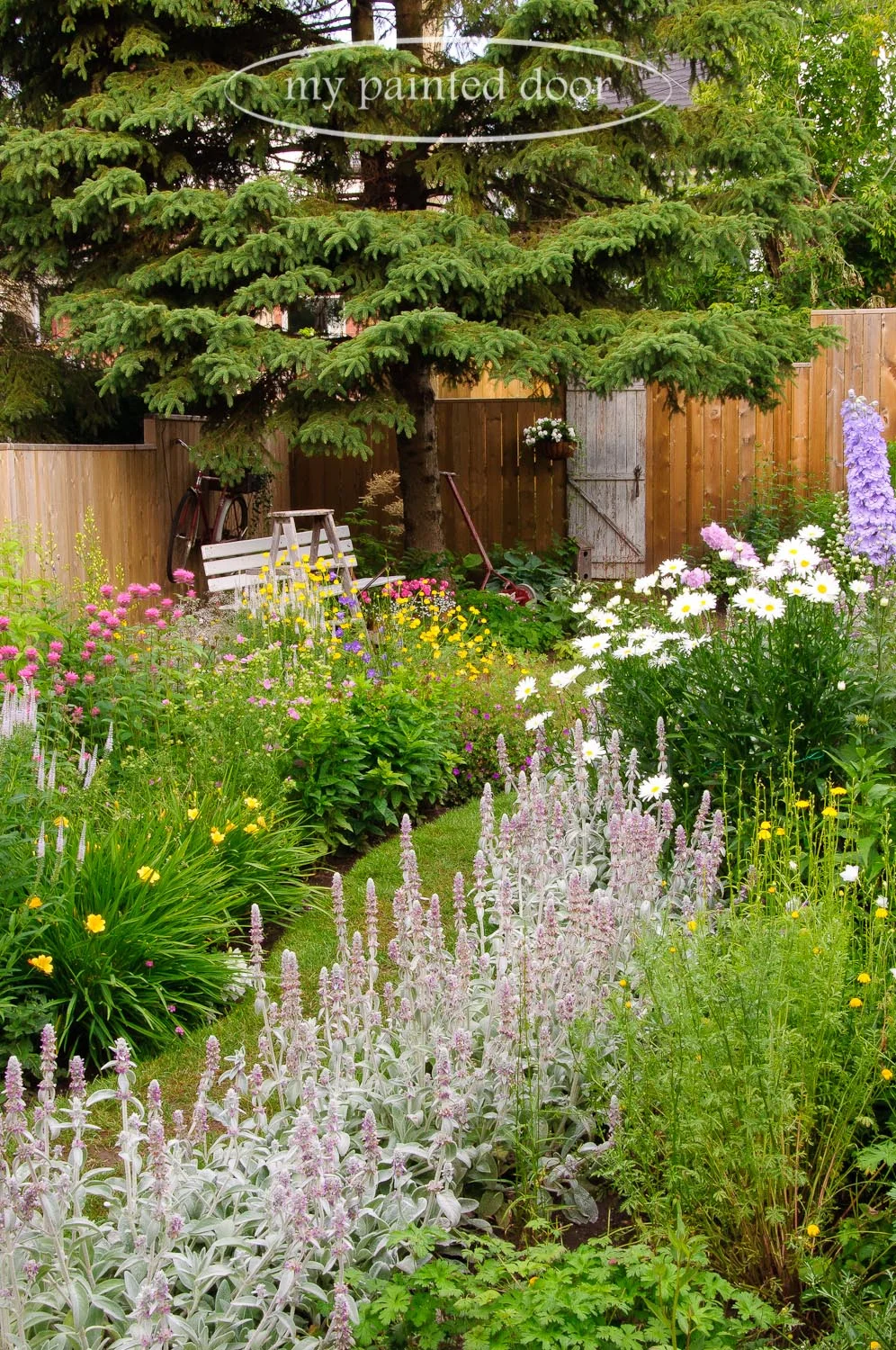My Country Garden - Sue Sikorski's zone 3 garden - Garden path leading to an old door.