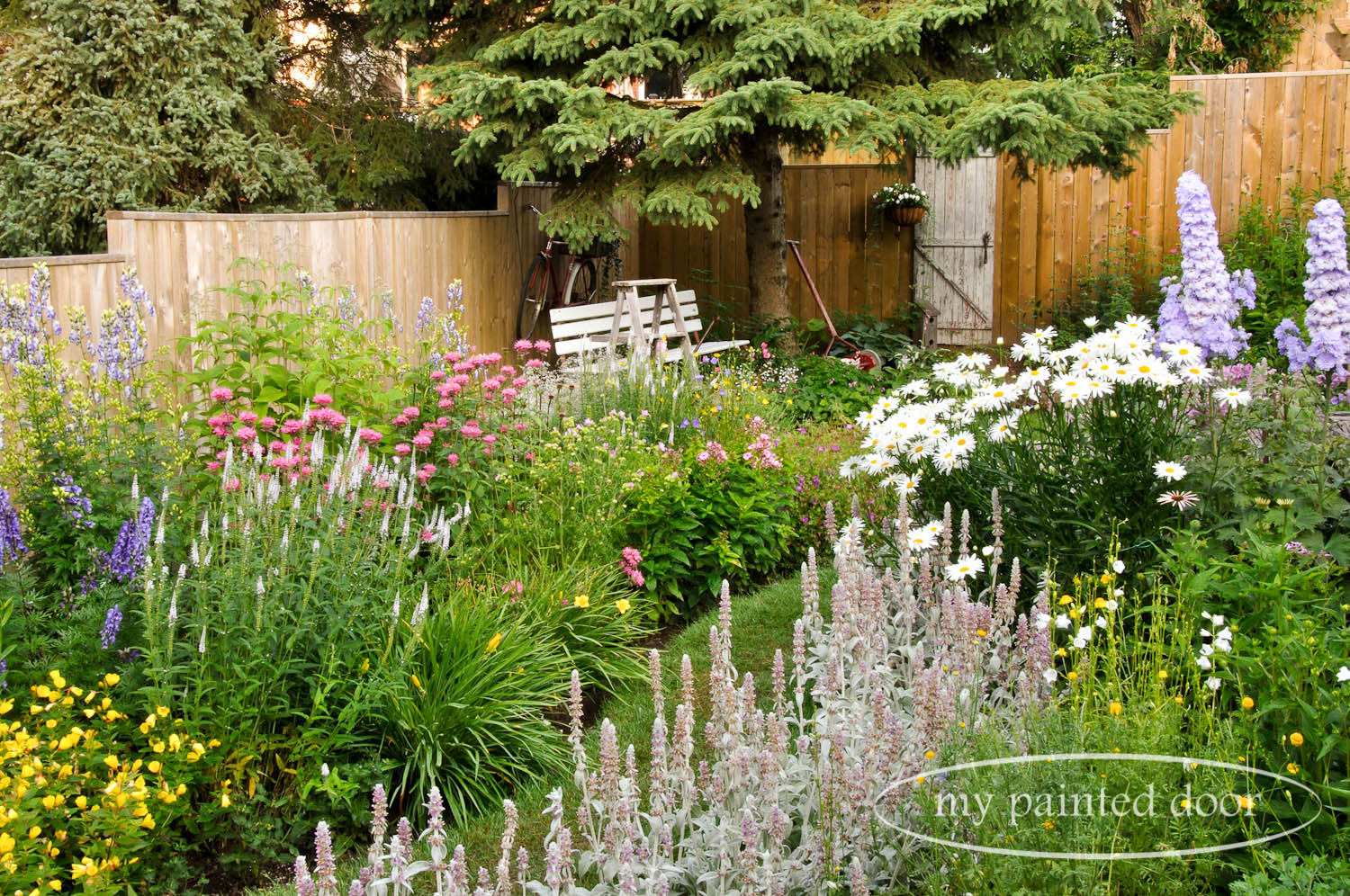 My Country Garden - Sue Sikorski's zone 3 garden - old bus bench in the garden.