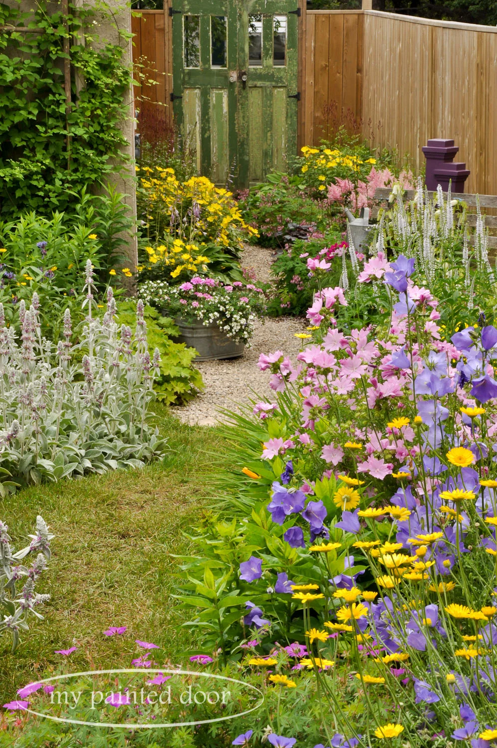 My Country Garden - Sue Sikorski's zone 3 garden - path leading to an old door.