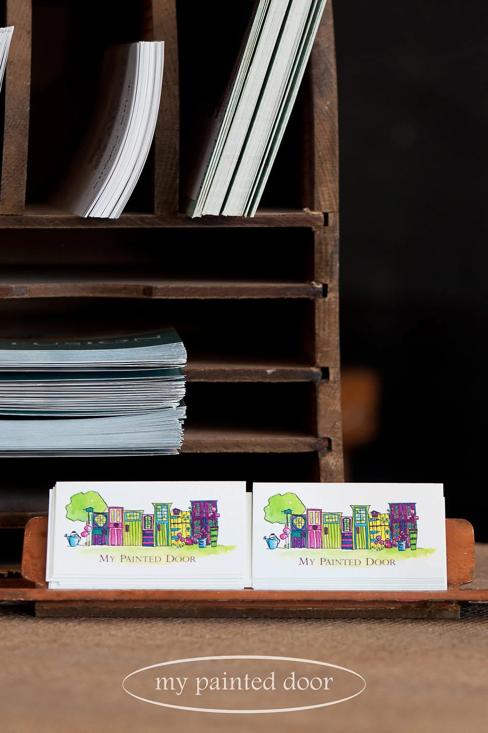 Mail slot from an old door used as a business card holder