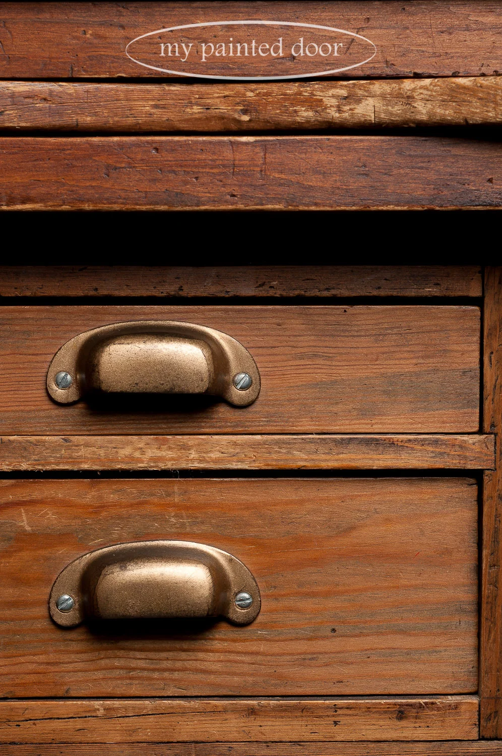 Drawer pulls on an antique post office desk.