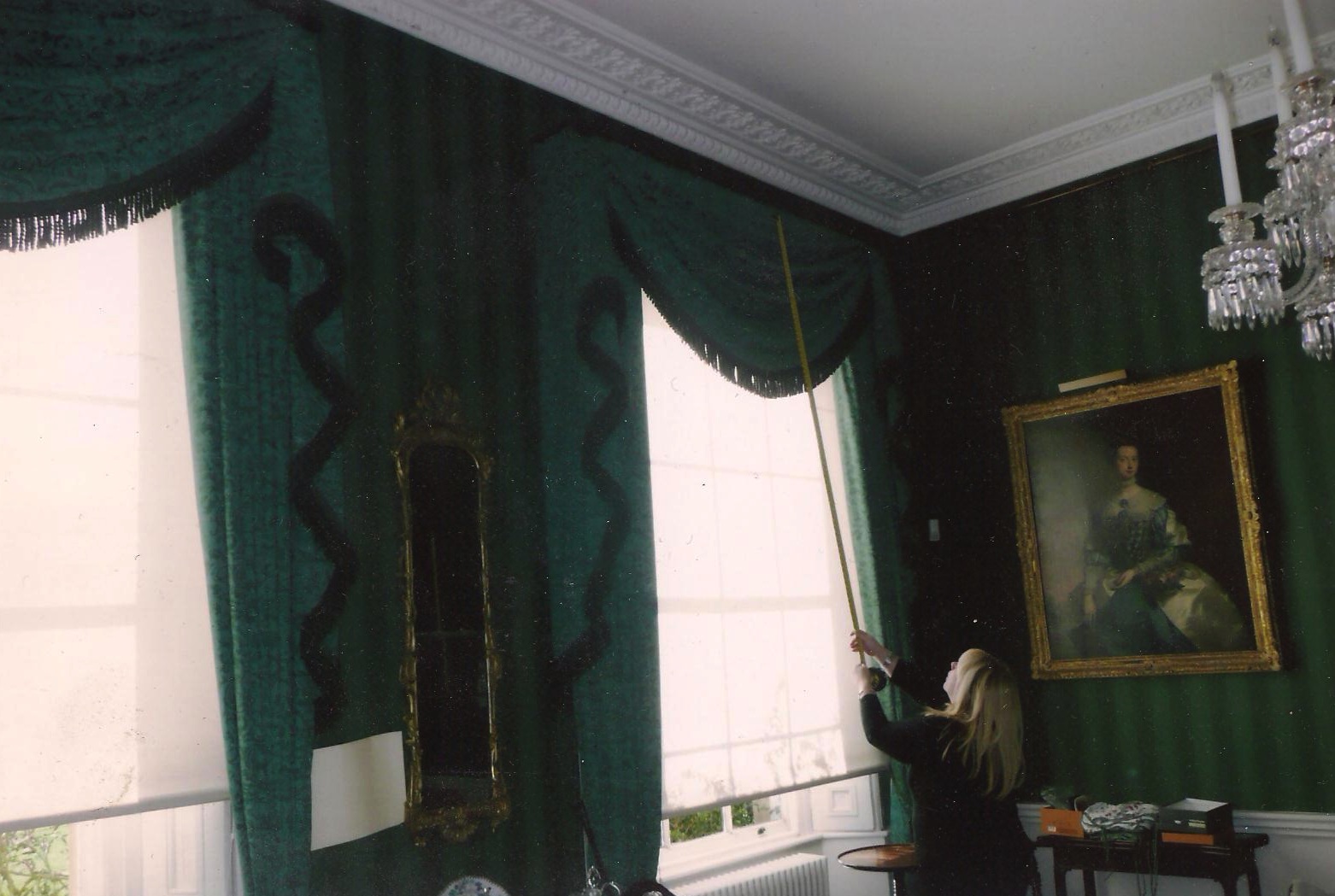 London- Teal green curtains with single swag and tail design with heavy bullion fringe trimming.