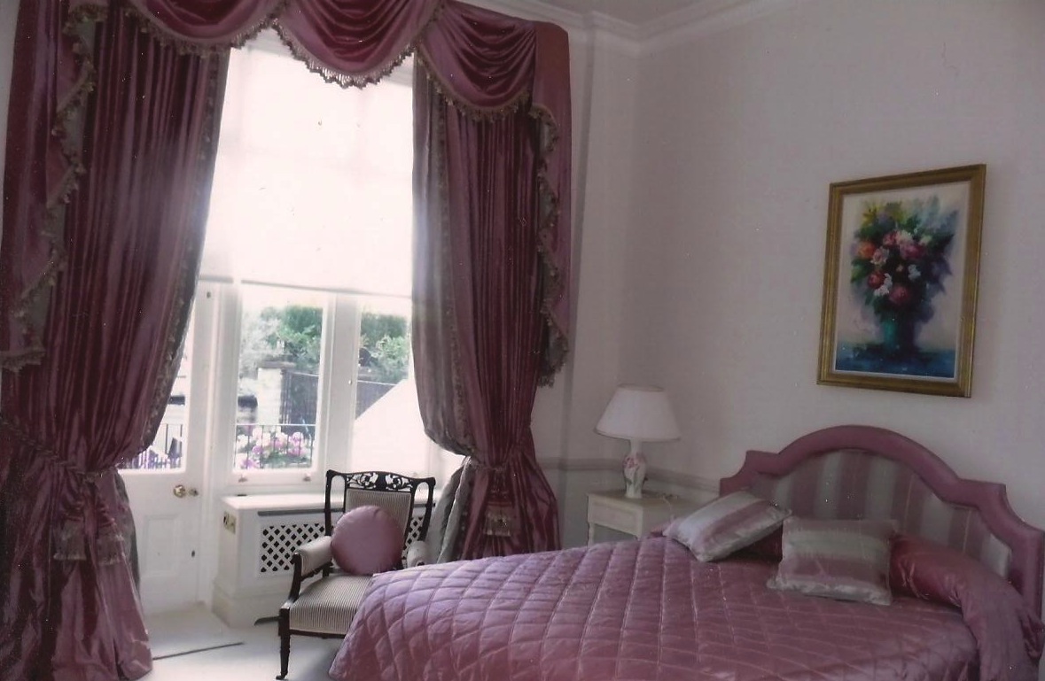 London- Dusty pink silk curtains with swags and tails. Matching quilted bedspread with pillow flap, shaped headboard and round cushion.