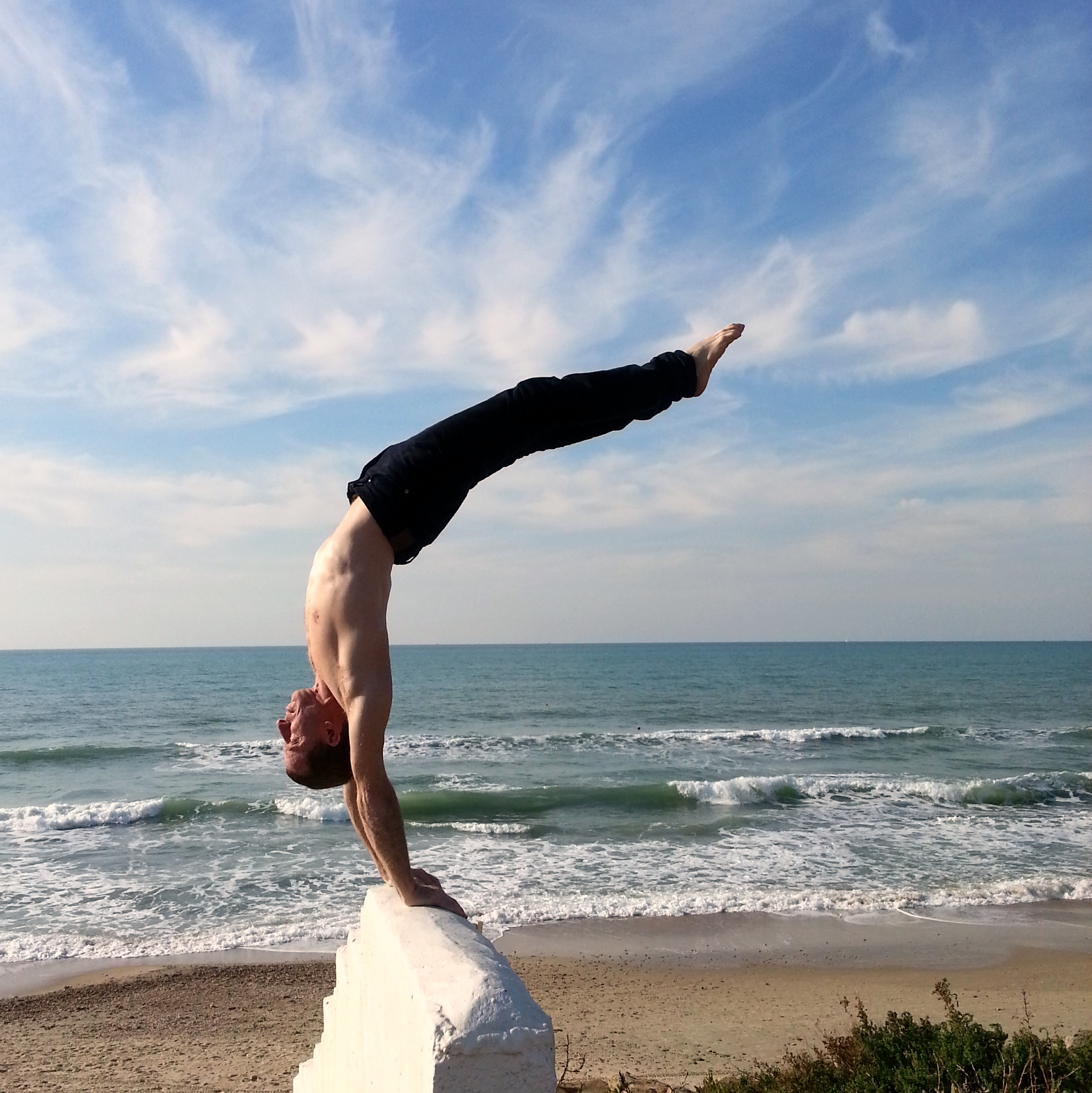 handstand on beach wall.jpg