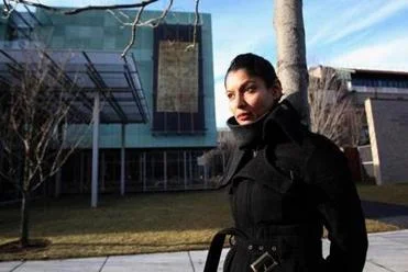 Artist Hamra Abbas in front of "Wall Hanging I" on the facade of the Isabella Stewart Gardner Museum.