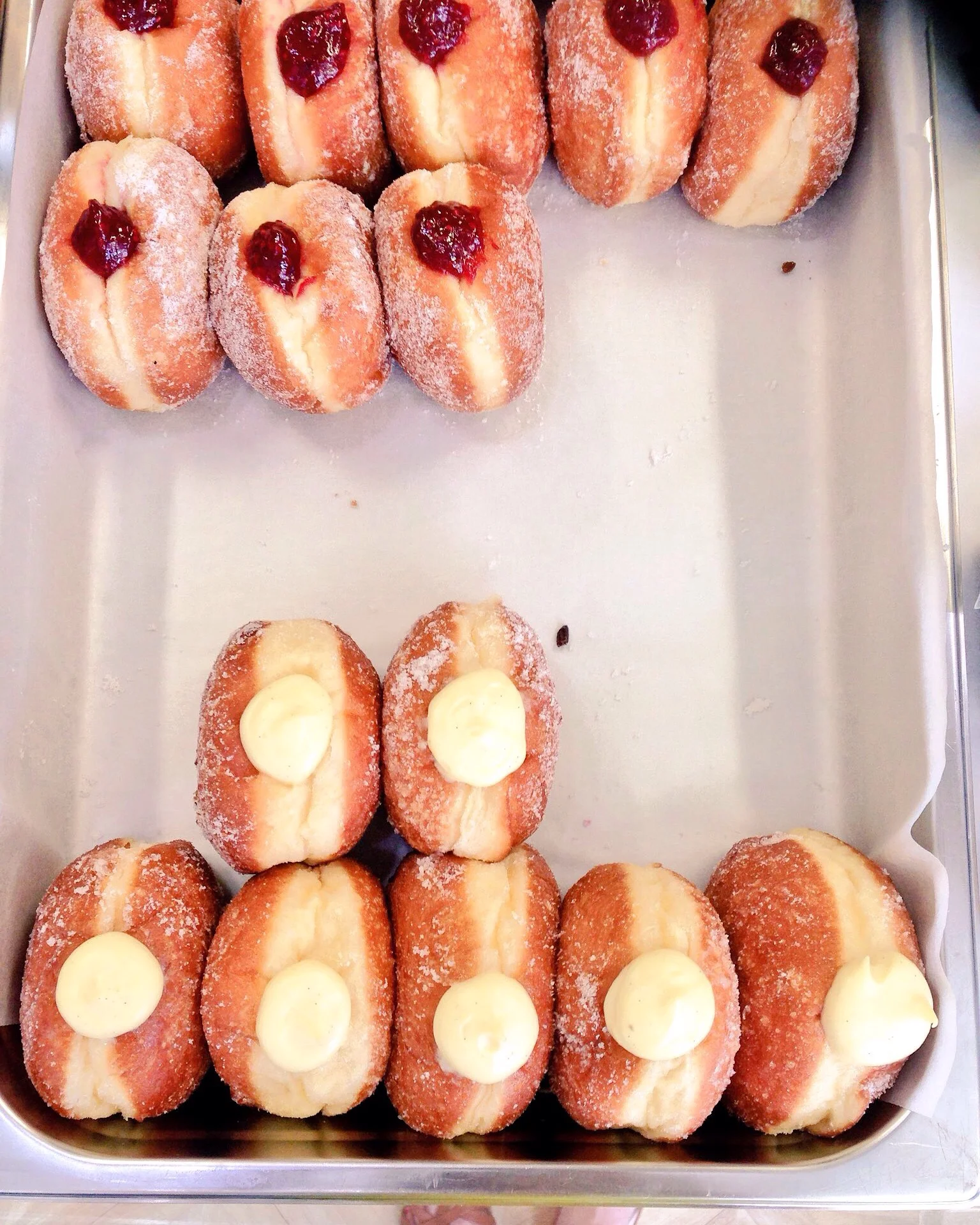 Some rather spectacular donuts at Bread Ahead in Old Street, London . When it was a choice between cold pizza or one of these for breakfast on Saturday, I chose the custard donut.