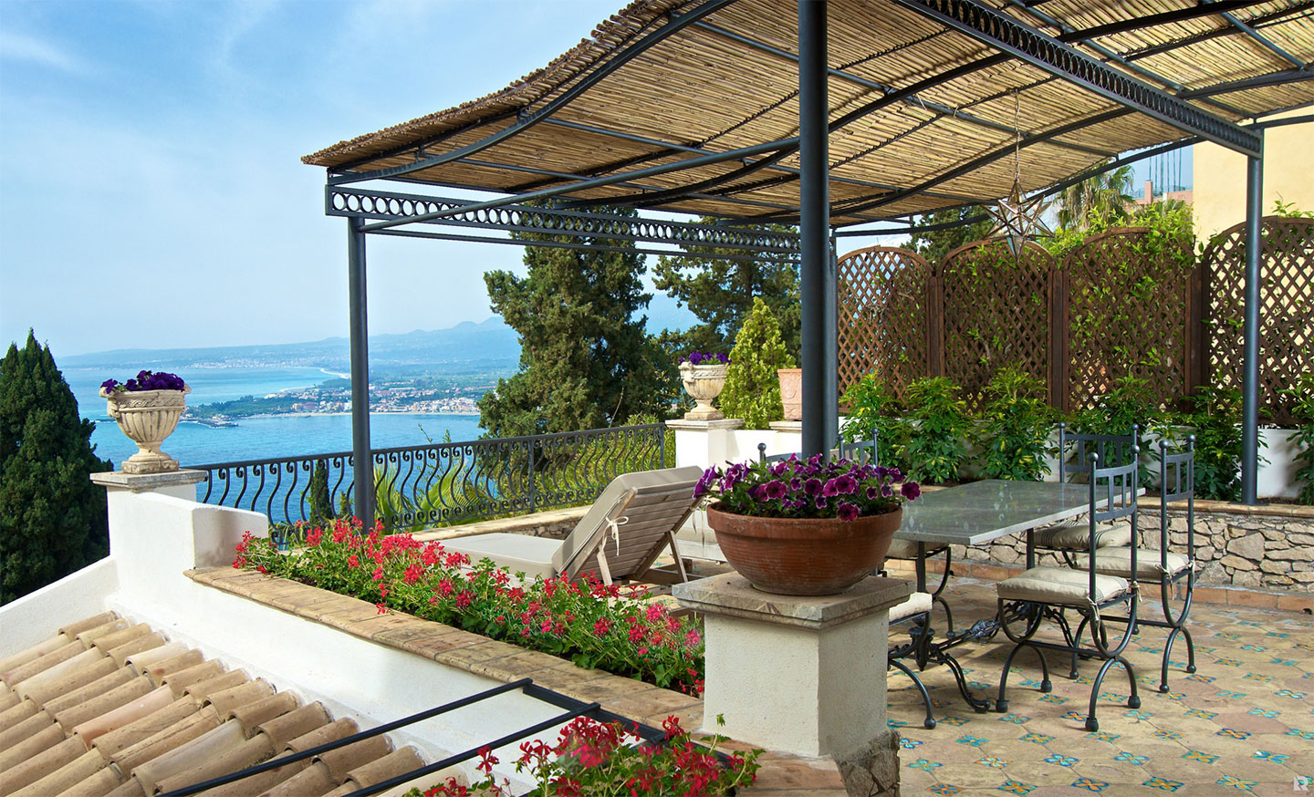 Villa Carlotta's terrace view. The hotel has a lush garden and a refreshing swimming pool terraced above the rose-coloured tiles of an ancient chapel.