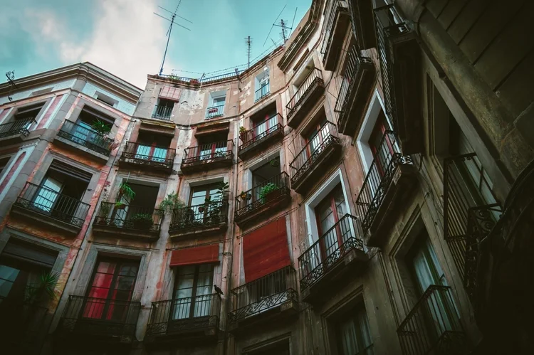 Balconies on a dark residential street in the Gothic Quarter.