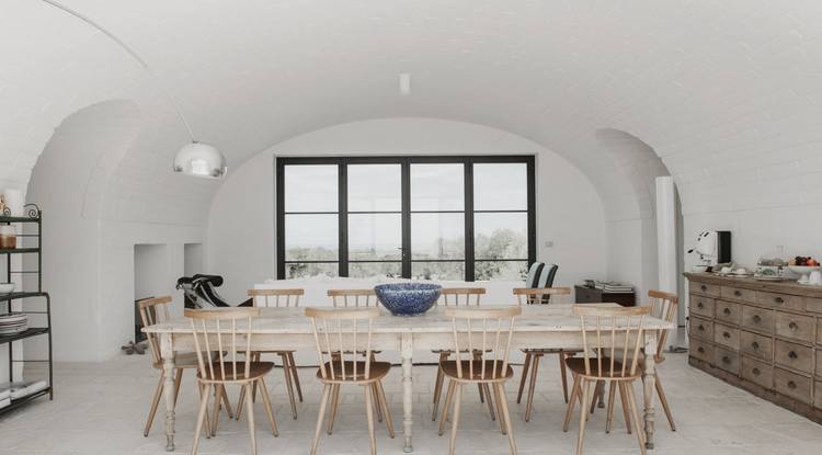 Open and inviting long wooden table for sharing dishes and memories. Image © Salva Lopez