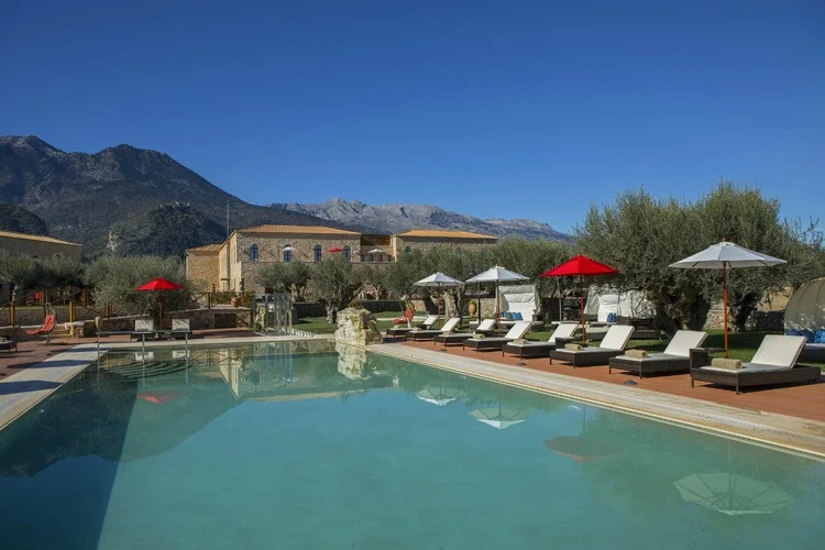 The natural landscapes surrounding the pool at Mystras Palace Resort.