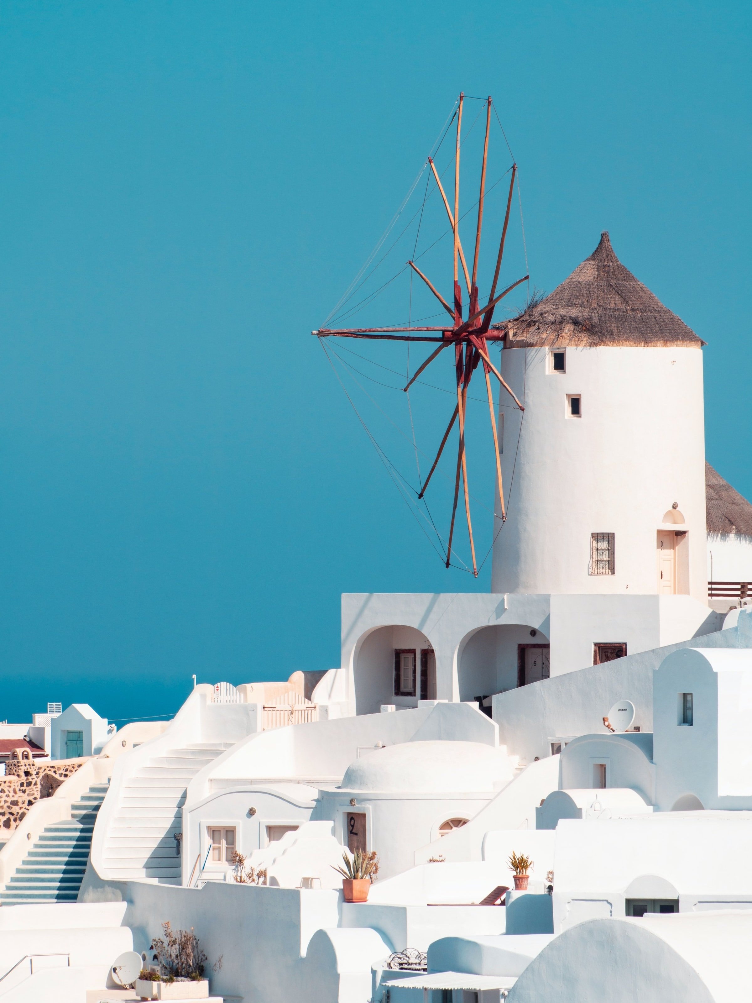 Oia, Santorini is a magical place with its windmills and whitewashed buildings