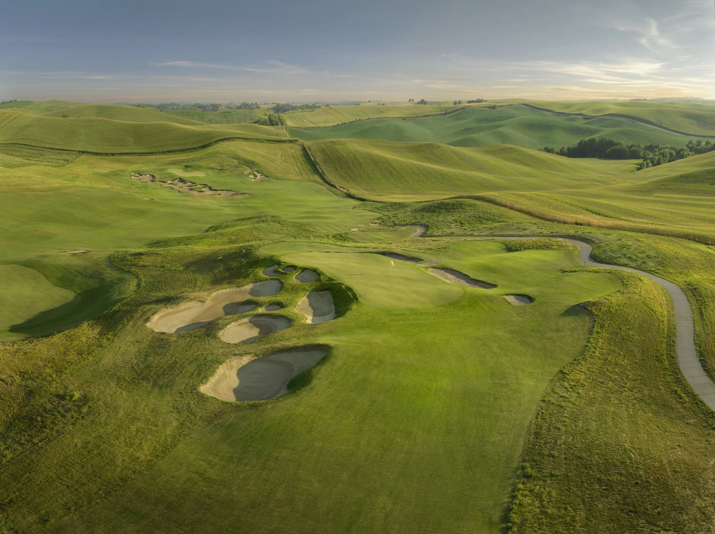 Aerial drone photograph of Landmand Golf Club showing fairways, greens, bunkers, and the surrounding prairie landscape from above
