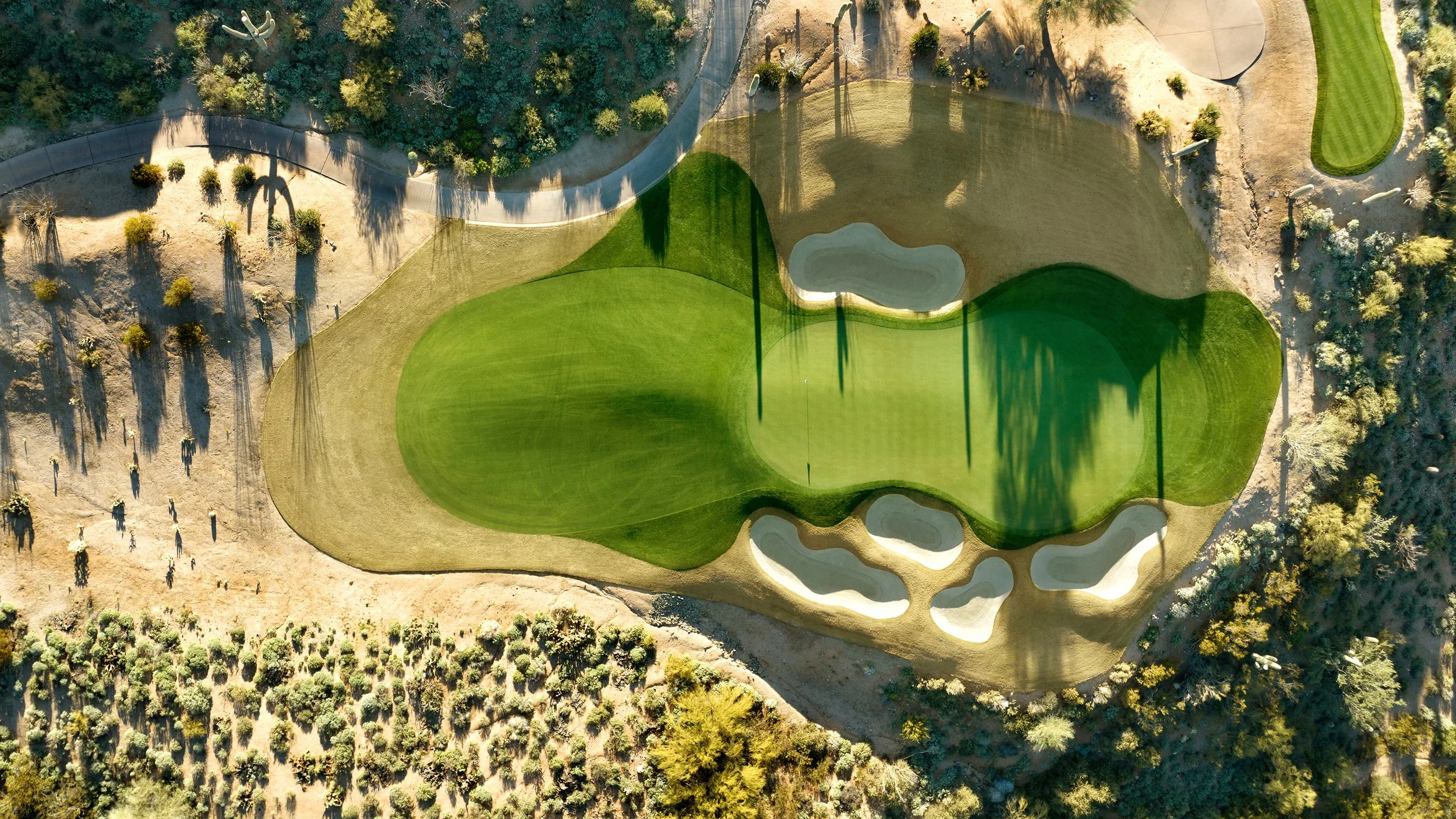 Aerial drone photograph of a golf course showing fairways, greens, bunkers, and surrounding landscape