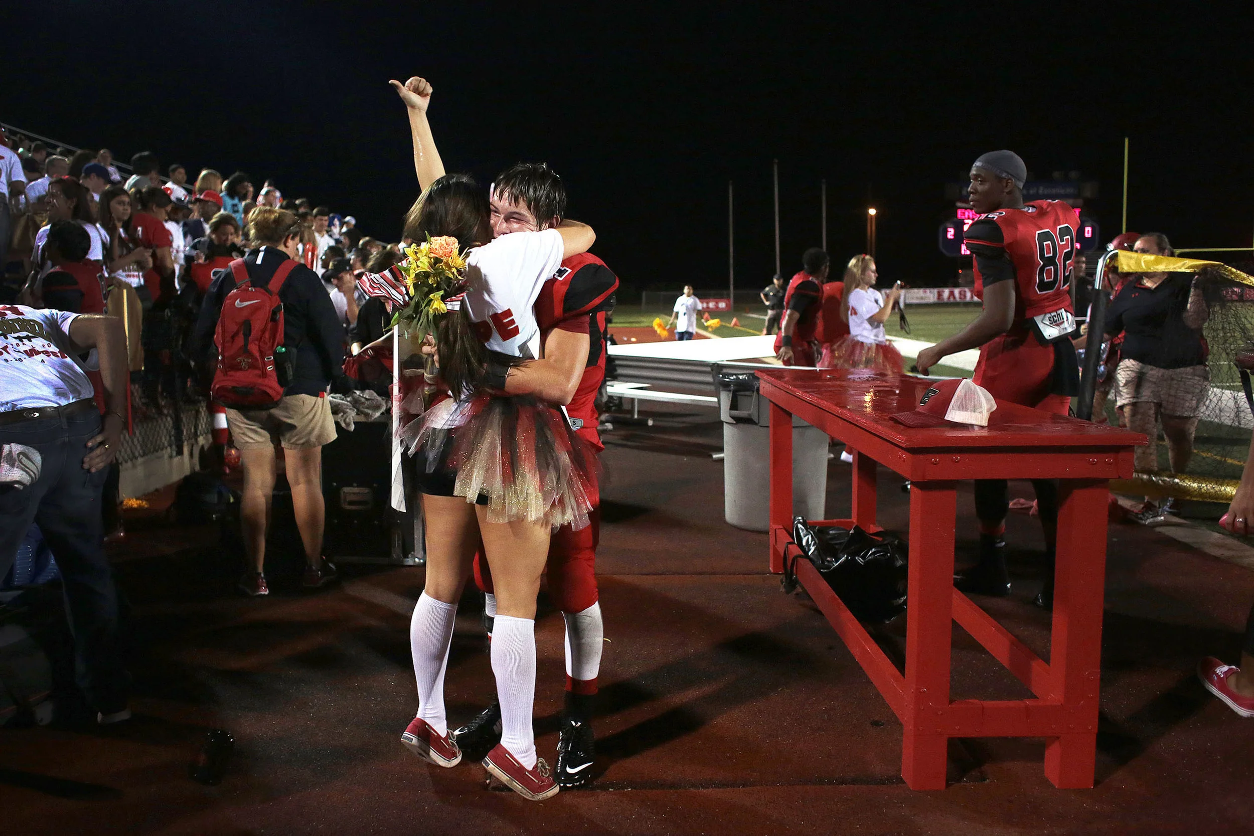   26 Sept. 2014, Victoria, TX --&nbsp; Victoria East flag runner Alicia Hernandez gives a thumbs up to the crowd after saying "yes" to her boyfriend Dillon Lippe's request to take her to Homecoming on Friday night after&nbsp;Victoria East High School