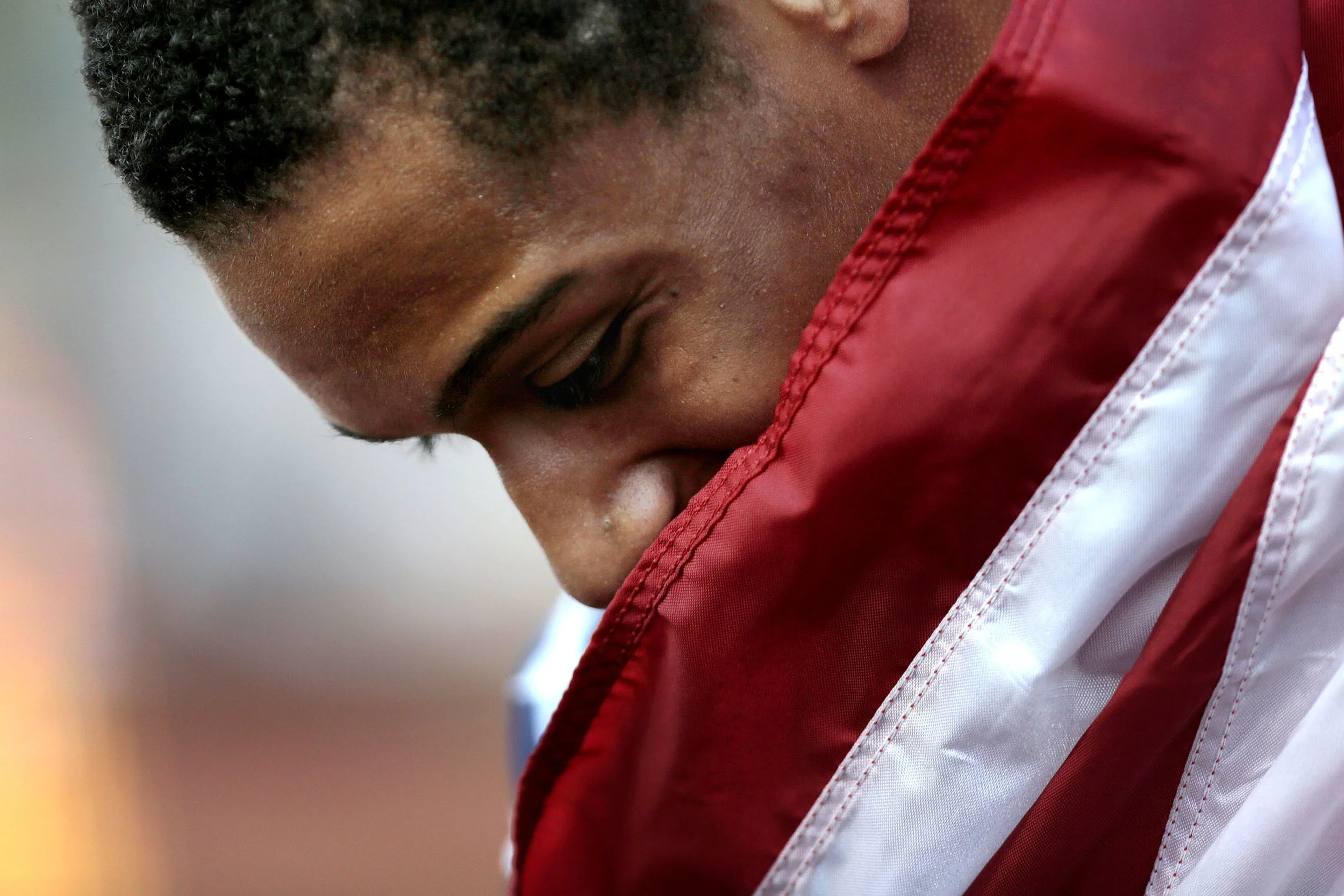  25 July 2014, Eugene, OR --&nbsp;USA's Trentavis Friday wraps himself in an American flag after winning the men’s 200 meter final with a time of 20.04 seconds on Day 4 of the IAAF World Junior Championships at Hayward Field in Eugene.&nbsp; (Copyrig