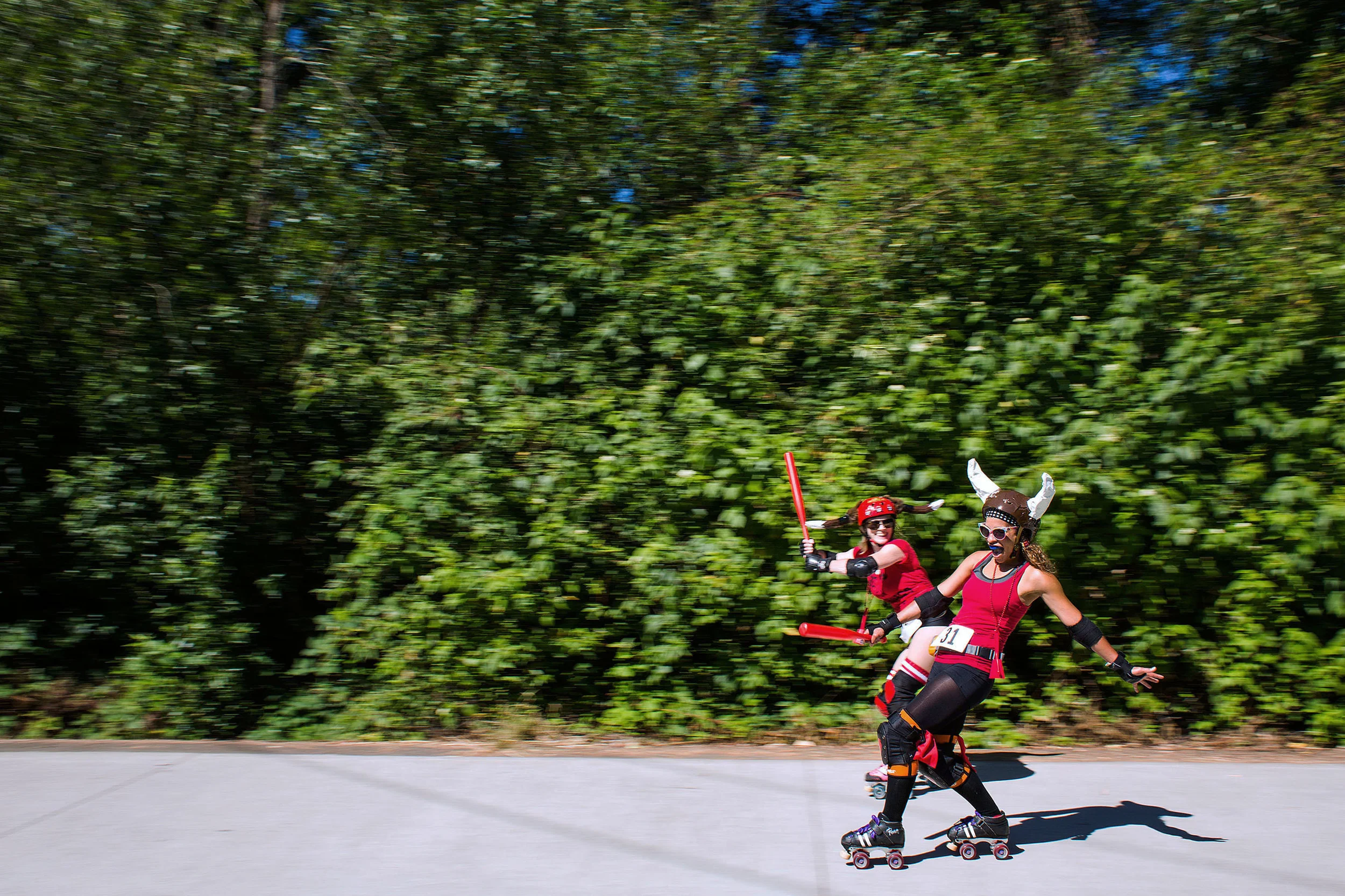  19 July 2014, Eugene, OR -- Rebecca Parvin, left, and Aiesa Johnston, right, race along the track at the end of the Running of the Bulls event on Saturday in Eugene. A Eugene twist on the Spanish Tradition, Running of the Bulls was put on by Pink Bu