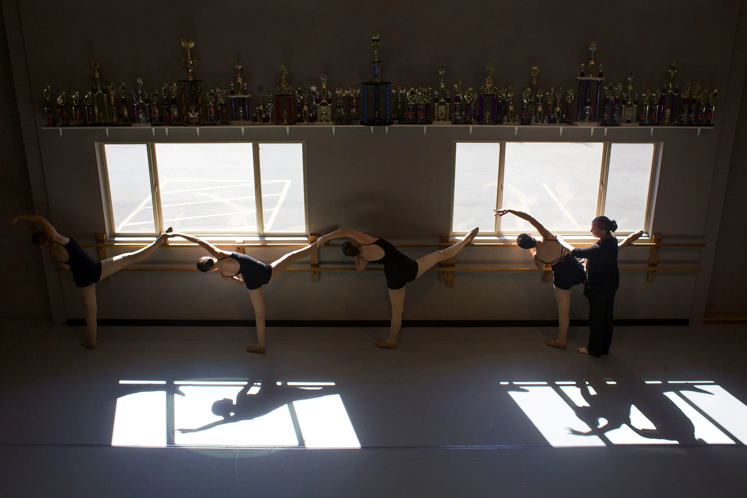   7 June&nbsp;2014, Eugene, OR --&nbsp; Trophies line the shelf above the dance floor in the main studio of All That! Dance on Saturday in Eugene. The advanced contemporary class practices positions at the bar as Sarah Beth Byrum, the owner and artis