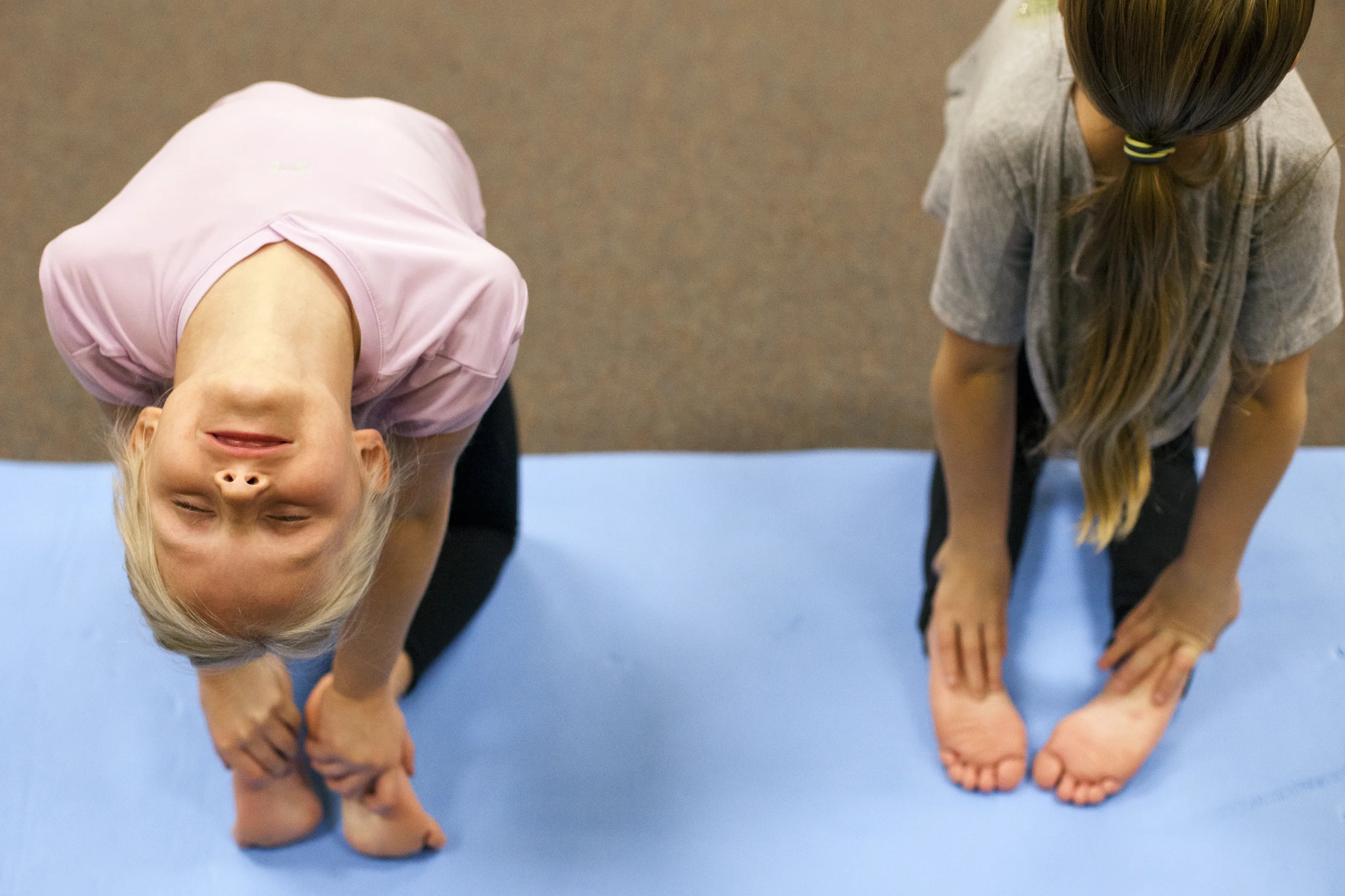  22 Jan. 2015, Ferdinand, IN --&nbsp;Adalyn Canen of Ferdinand, 7, left, leans&nbsp;back in the camel pose during a children’s yoga class Thursday evening at the Tri-County YMCA in Ferdinand. Rachel Hassfuther of Ferdinand, 8, right, also tried the m