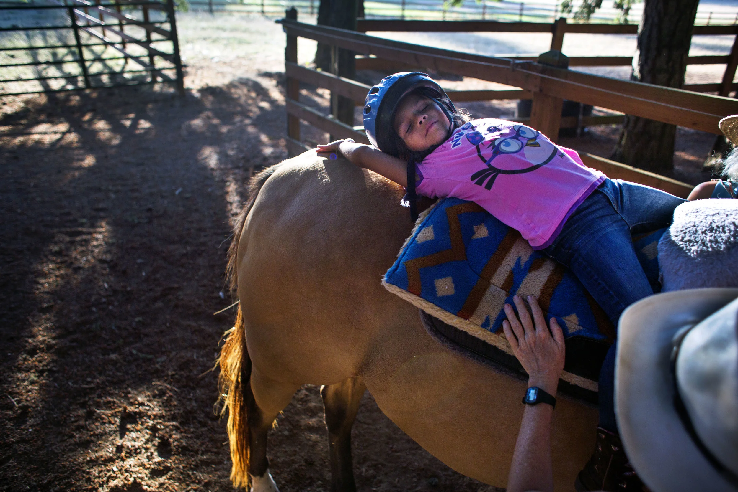   6 Aug. 2014, Pleasant Hill, OR --&nbsp; Kendra Pina, 4, leans back to relax and connect with her horse during her lesson on Wednesday at Soaring Spirit Therapeutic Center in Pleasant Hill. Kendra was diagnosed with autism when she was 2&nbsp;years&