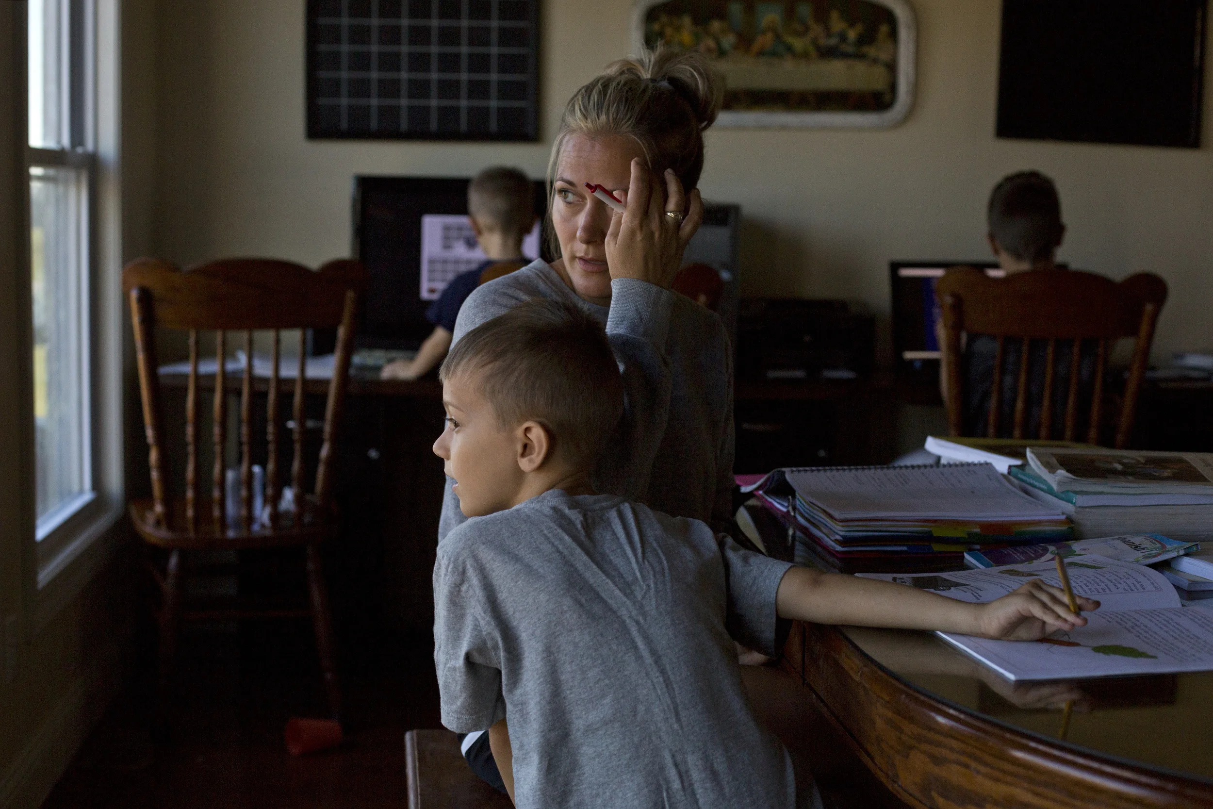  Kim Hotop and her son Andrew, 7, work on Andrew’s schoolwork together at the kitchen on Tuesday, Sept. 22. Jared and Kim want their children to have an education more steeped in Creationism and Catholic theology than the local Catholic school offers