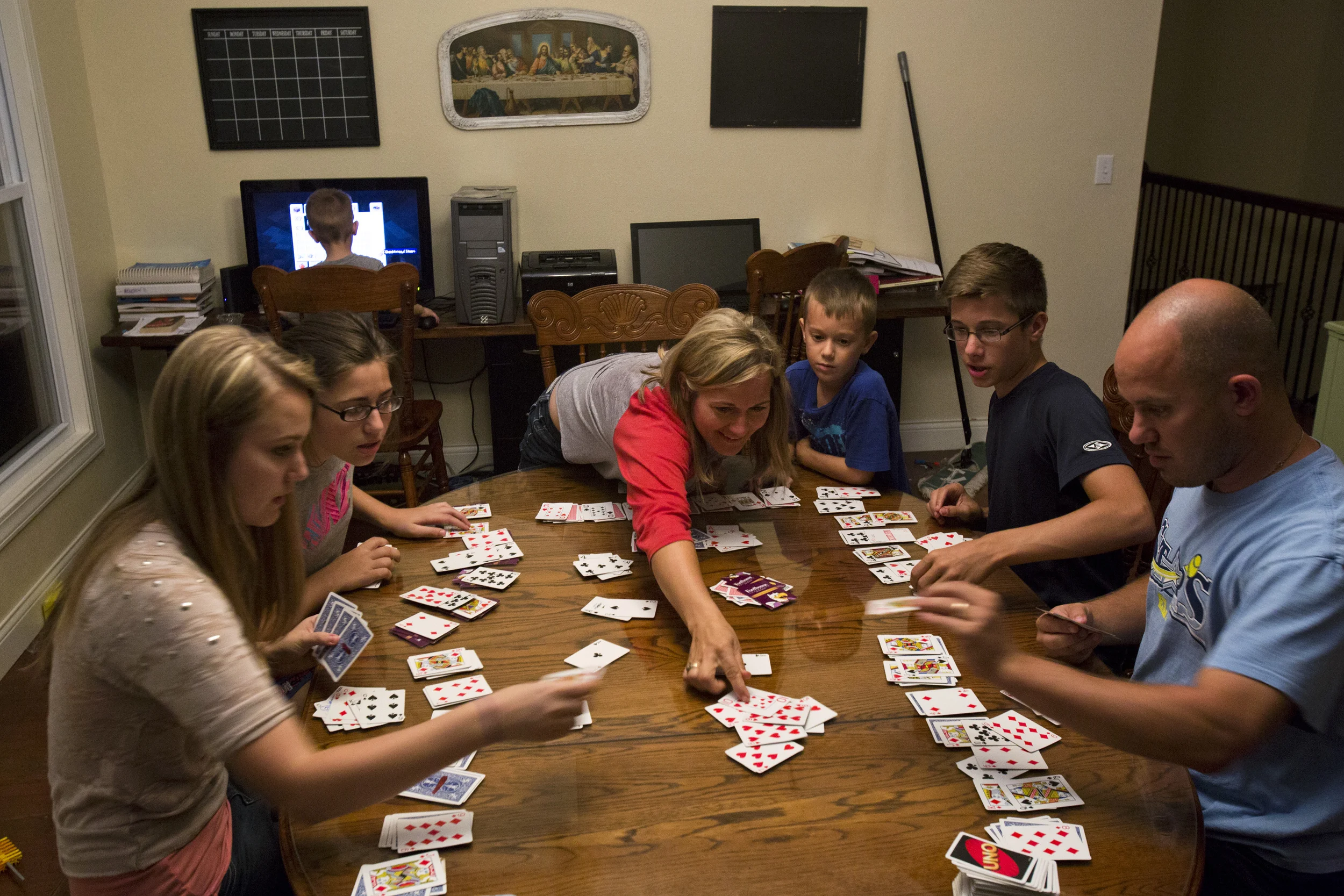  The Hotops play “Pounce,” a game passed down from Jared’s family, after supper at their home on Wednesday, Sept. 23. In addition to service on Sunday mornings and reflection at church on Sunday evenings, the Hotops try to plan family activities at h