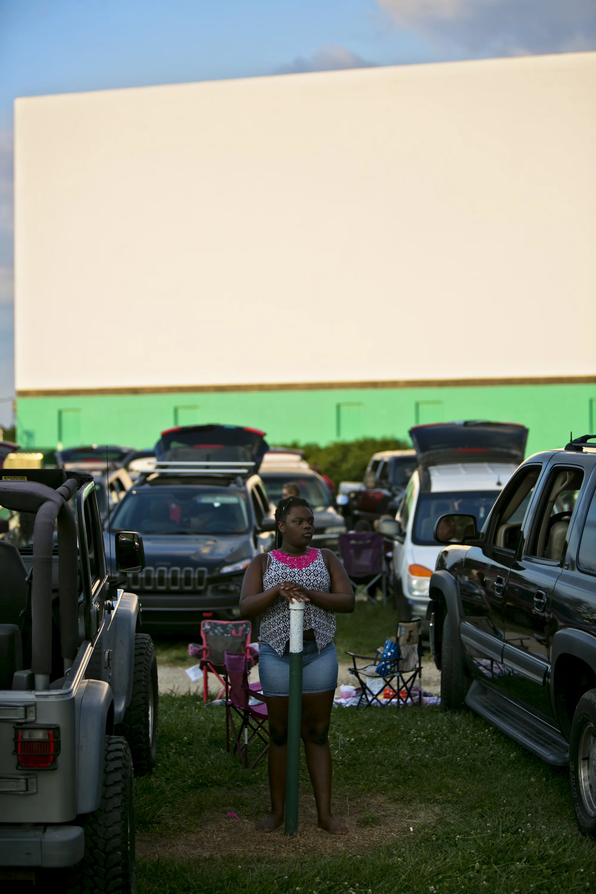   Amiah Moorman of Owensboro, 11, waited by her family’s car as the main screen’s viewing area filled with cars for the opening night of “Finding Dory” on June 17.  
